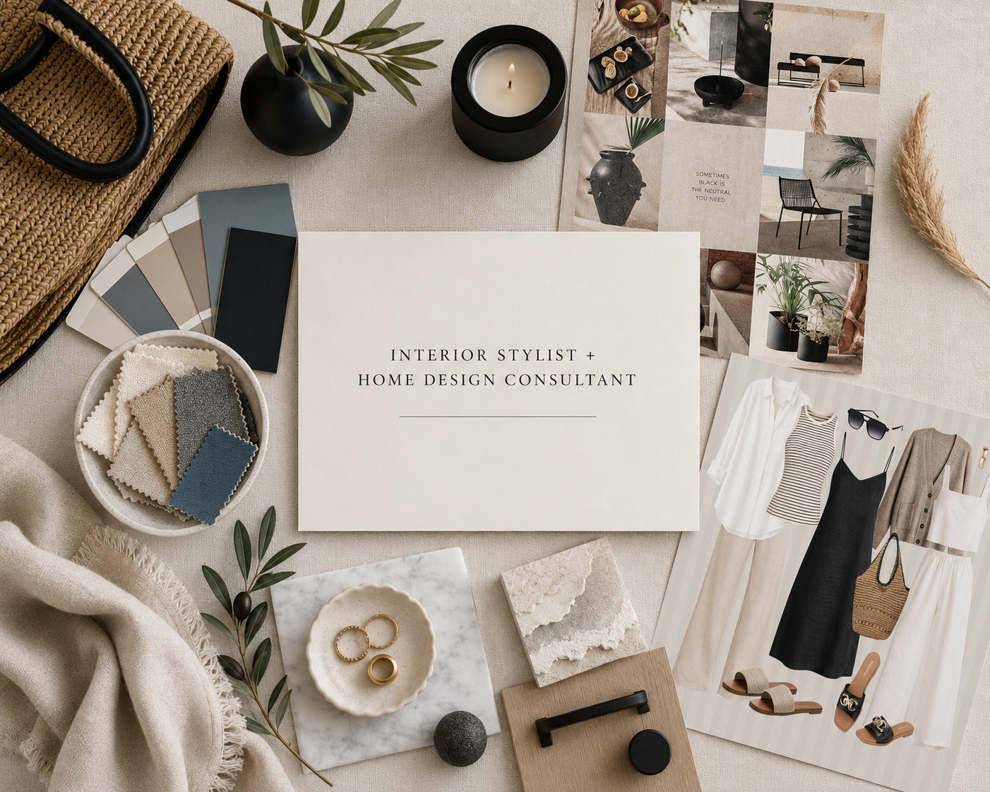 A flat lay of interior design and fashion materials, including paint swatches, fabric samples, jewelry, magazines, candles, plants, and a sign that reads 'Interior Stylist + Home Design Consultant'.