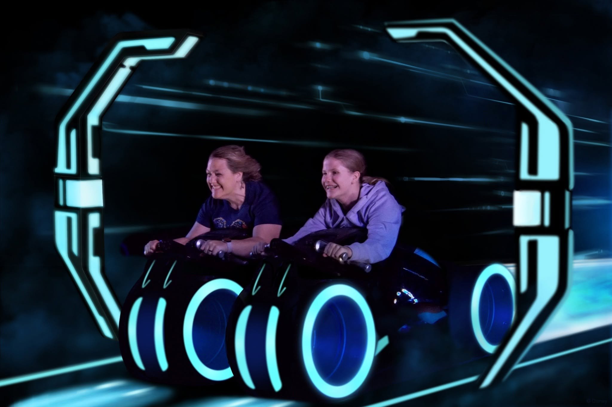 Two women ride a futuristic vehicle with a neon light neon outline, in a digital or virtual environment.