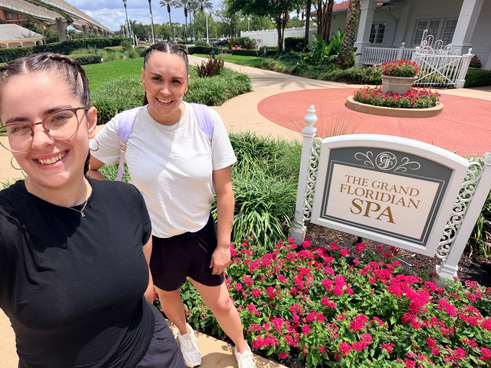 travel agent standing in front of the grand floridian spa in disney world