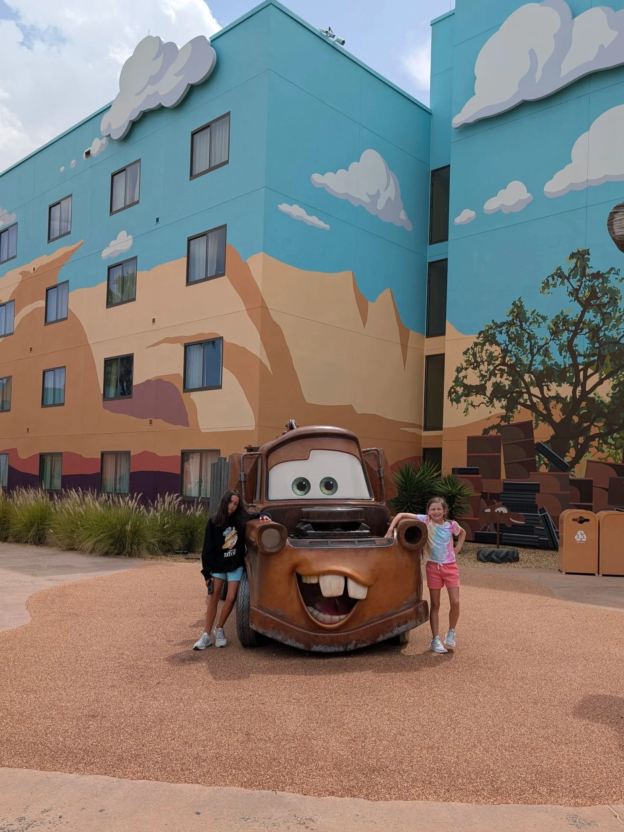 Children standing with Mater outside Disney's Art of Animation Resort at Walt Disney World.
