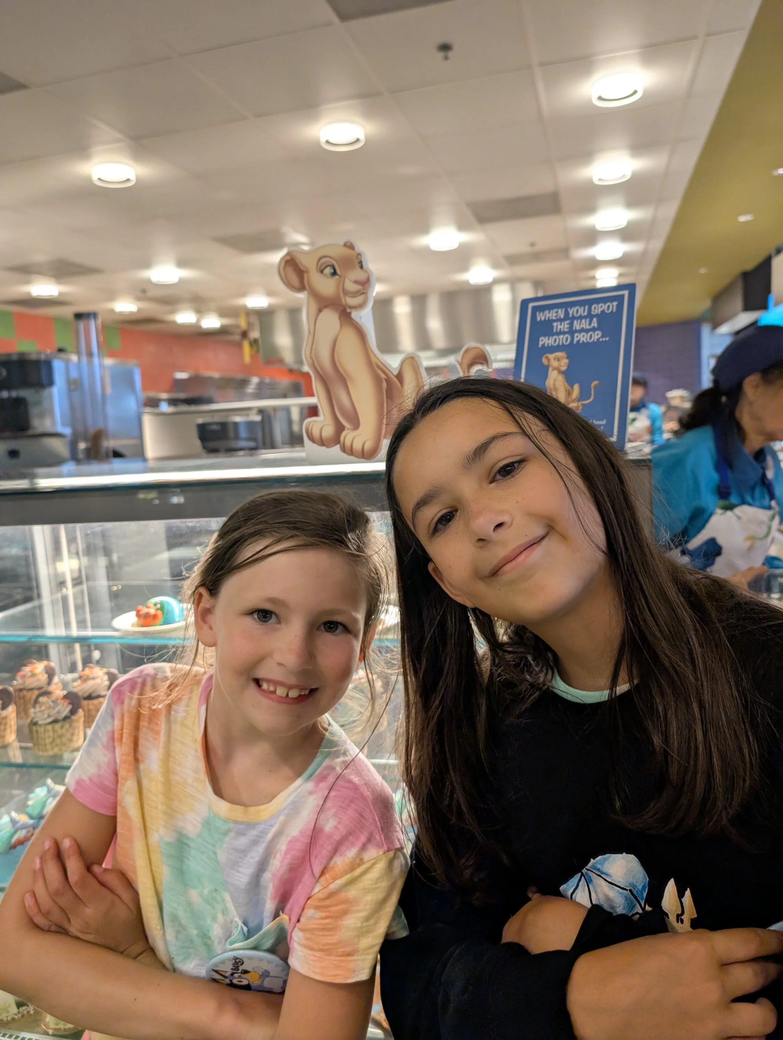 Two children enjoying a quick-service meal during a Disney World family vacation.