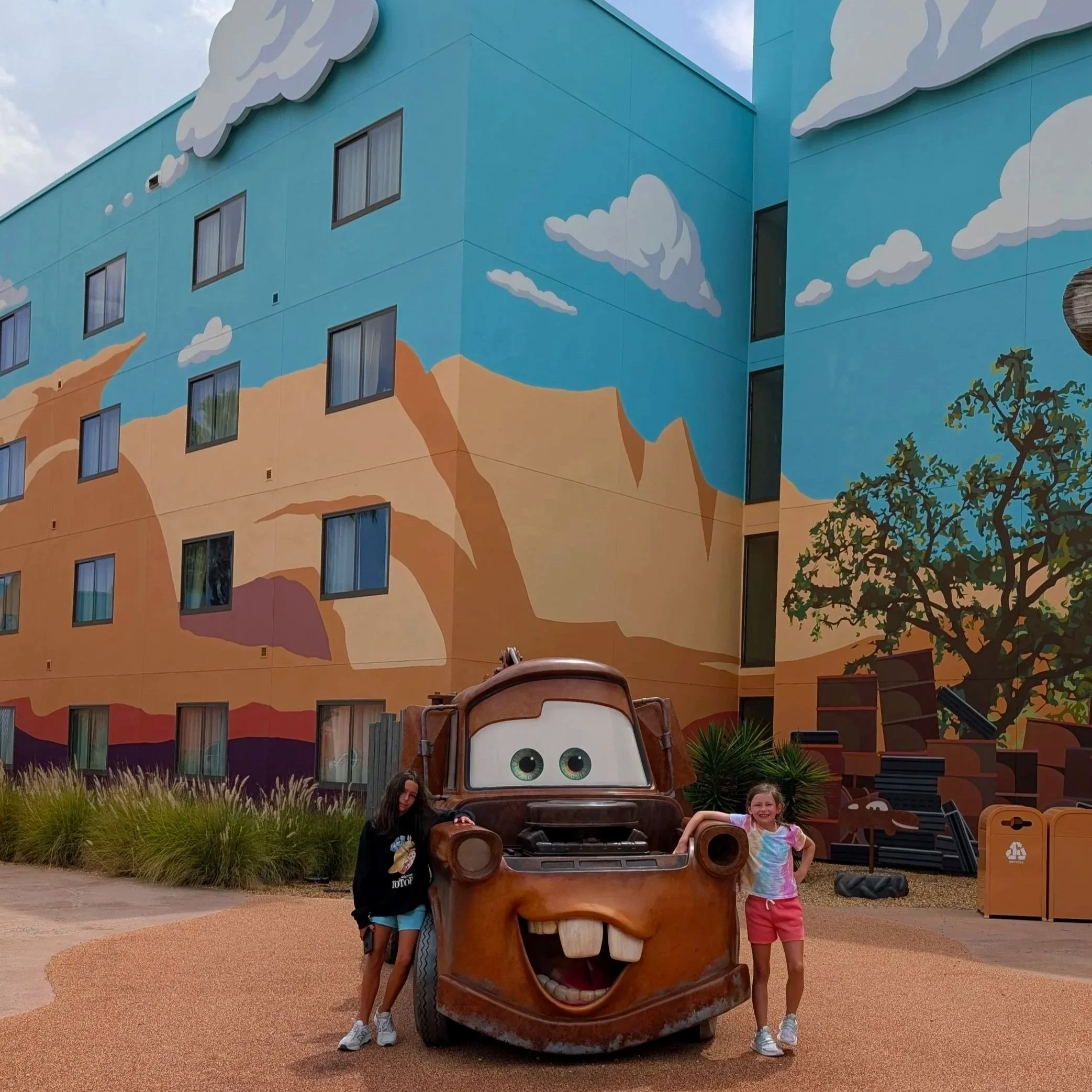 children standing next to Tow Mater at Art of Animation in Disney World