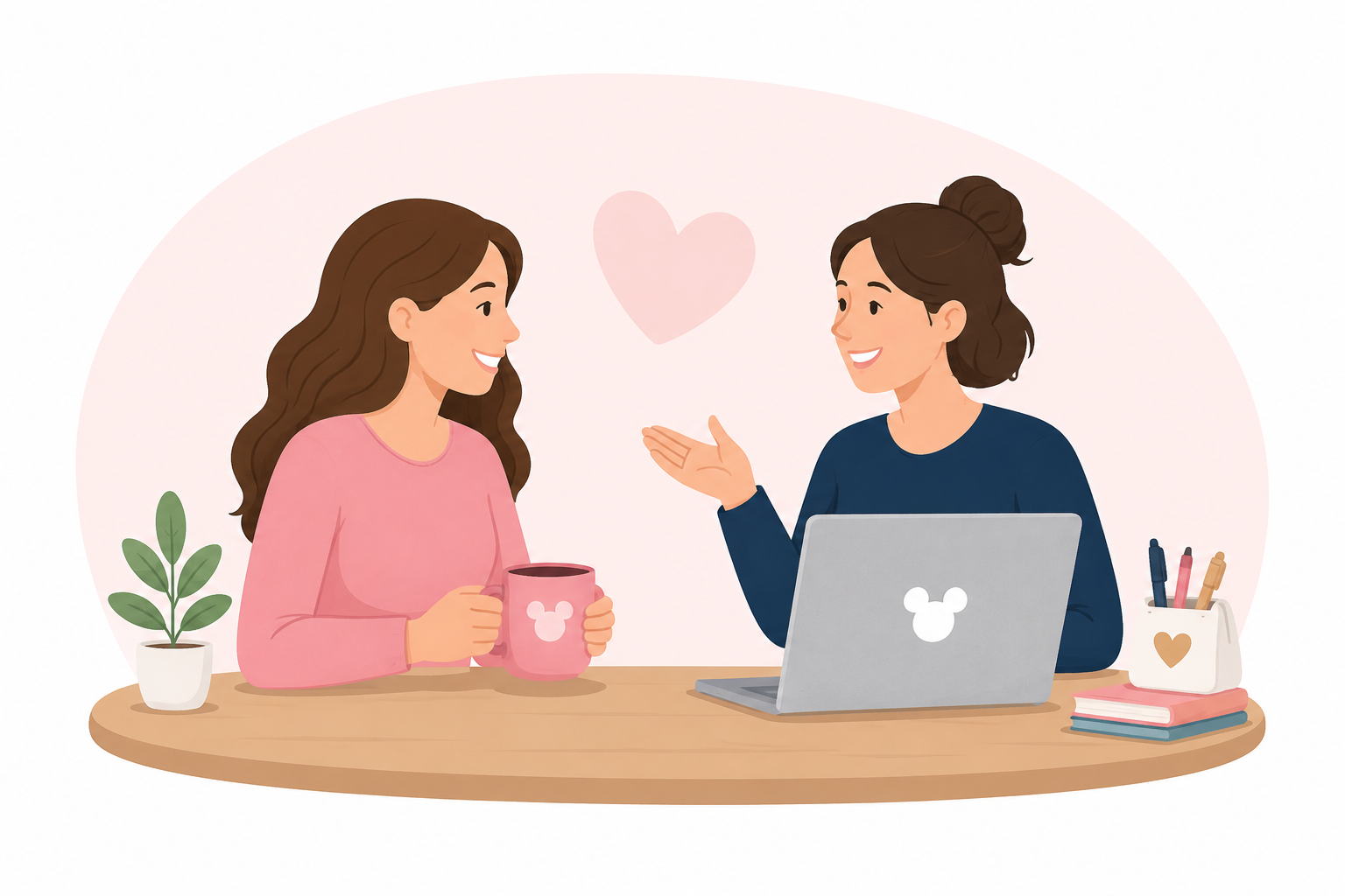 Two women sit at a wooden table talking happily, one holding a pink mug, the other gesturing with her hand, with a heart symbol above them, a potted plant on the table, and a laptop with a Mickey Mouse logo, alongside notebooks and pens.