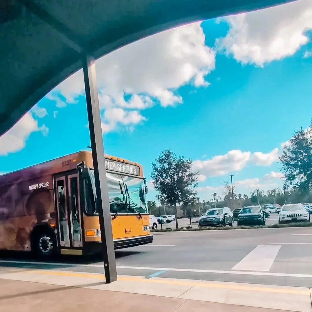 Disney bus pulling into the bus station at a disney resort