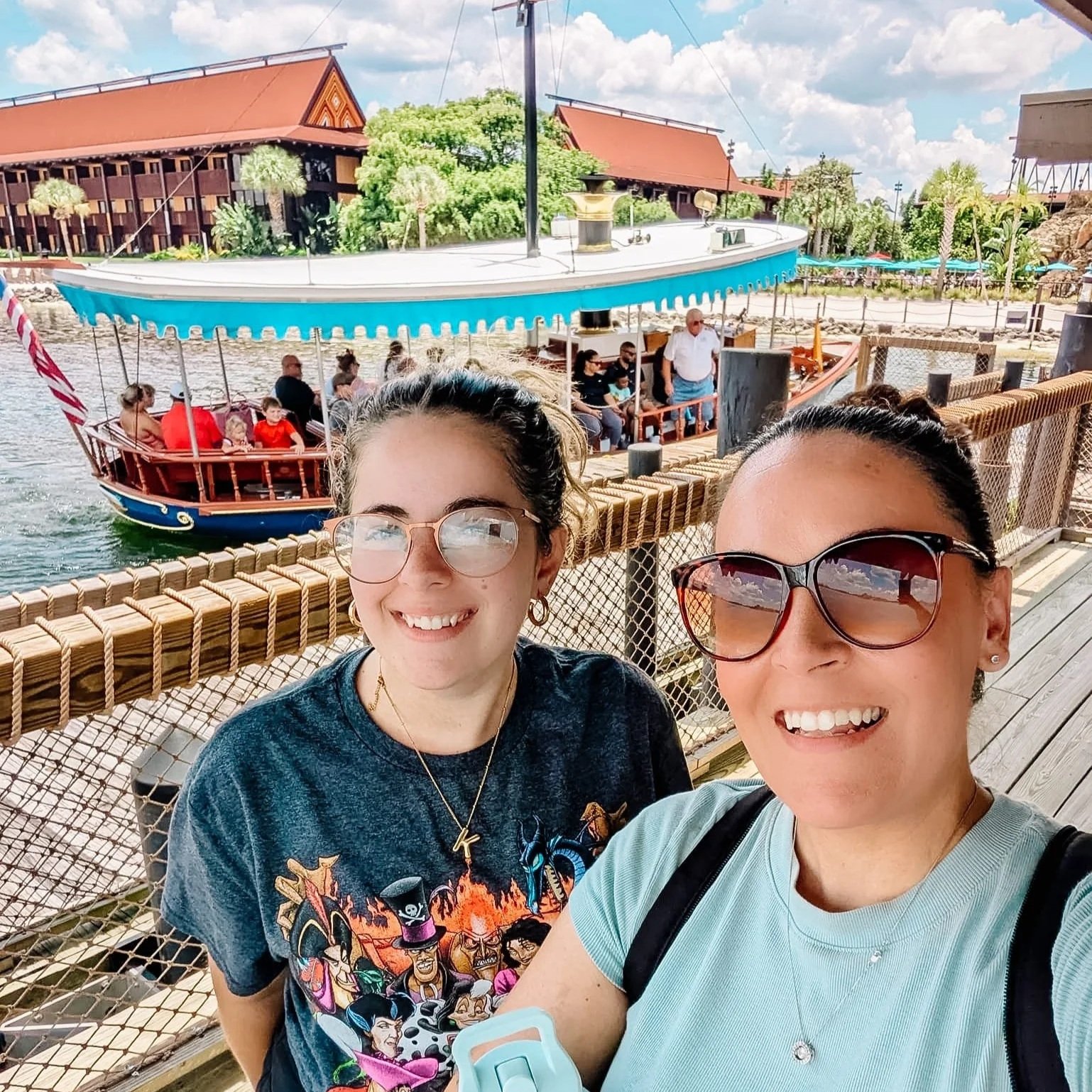 travel agent on the boat dock at Polynesian Village at Diseny World wtih a boat and resort behind her