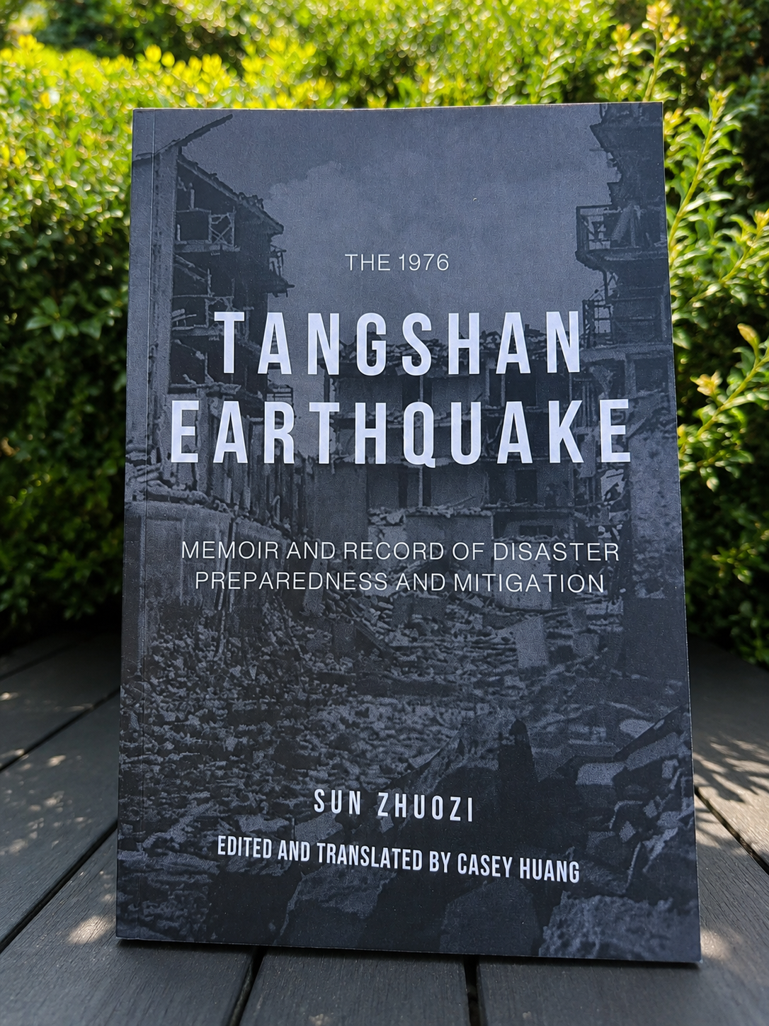 Cover of The 1976 Tangshan Earthquake: Memoir and Record of Disaster Preparedness and Mitigation by Sun Zhuozi, edited and translated by Casey Huang. The cover shows a damaged building with debris.