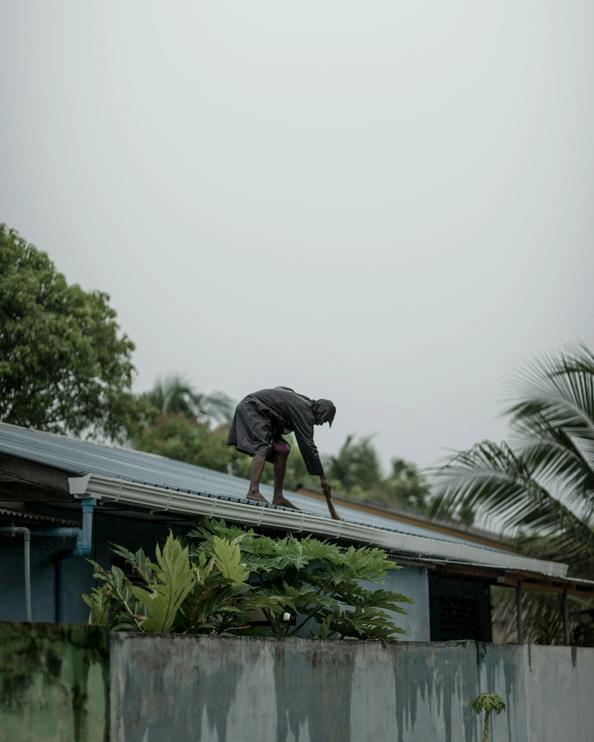 Oranssi technician working on a roof project