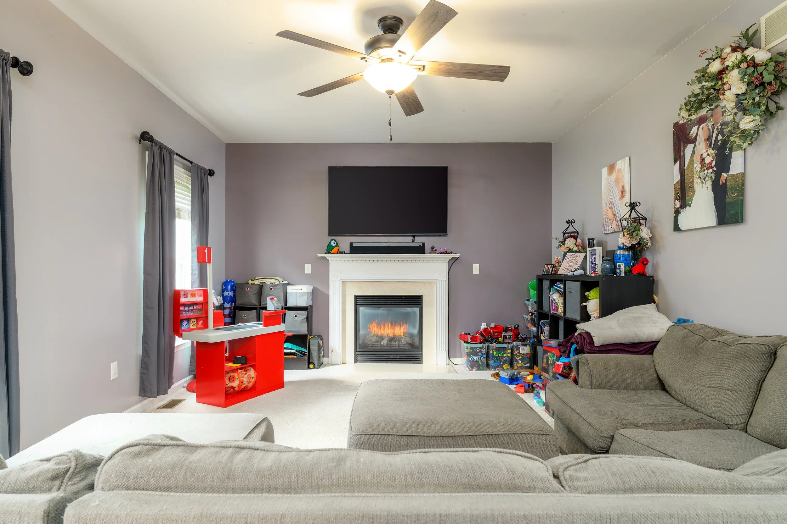 Family room featuring gas fireplace accent wall and sectional seating interior flambient real estate media Carlisle PA