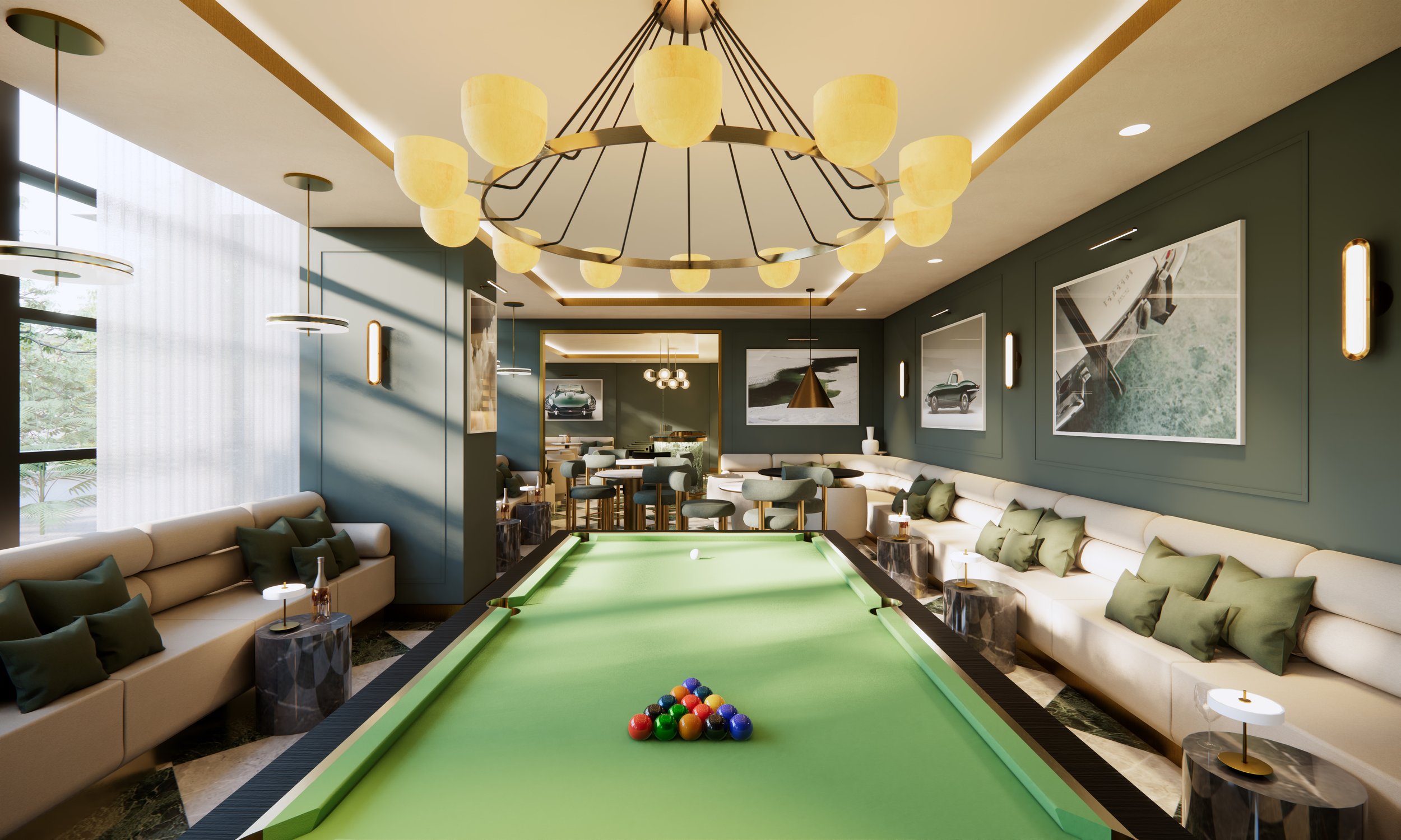 Interior of a modern lounge with a billiards table, beige sofas with green cushions, wall art photos of luxury cars, large windows with white curtains, and unique lighting fixtures including a chandelier and hanging lamps.