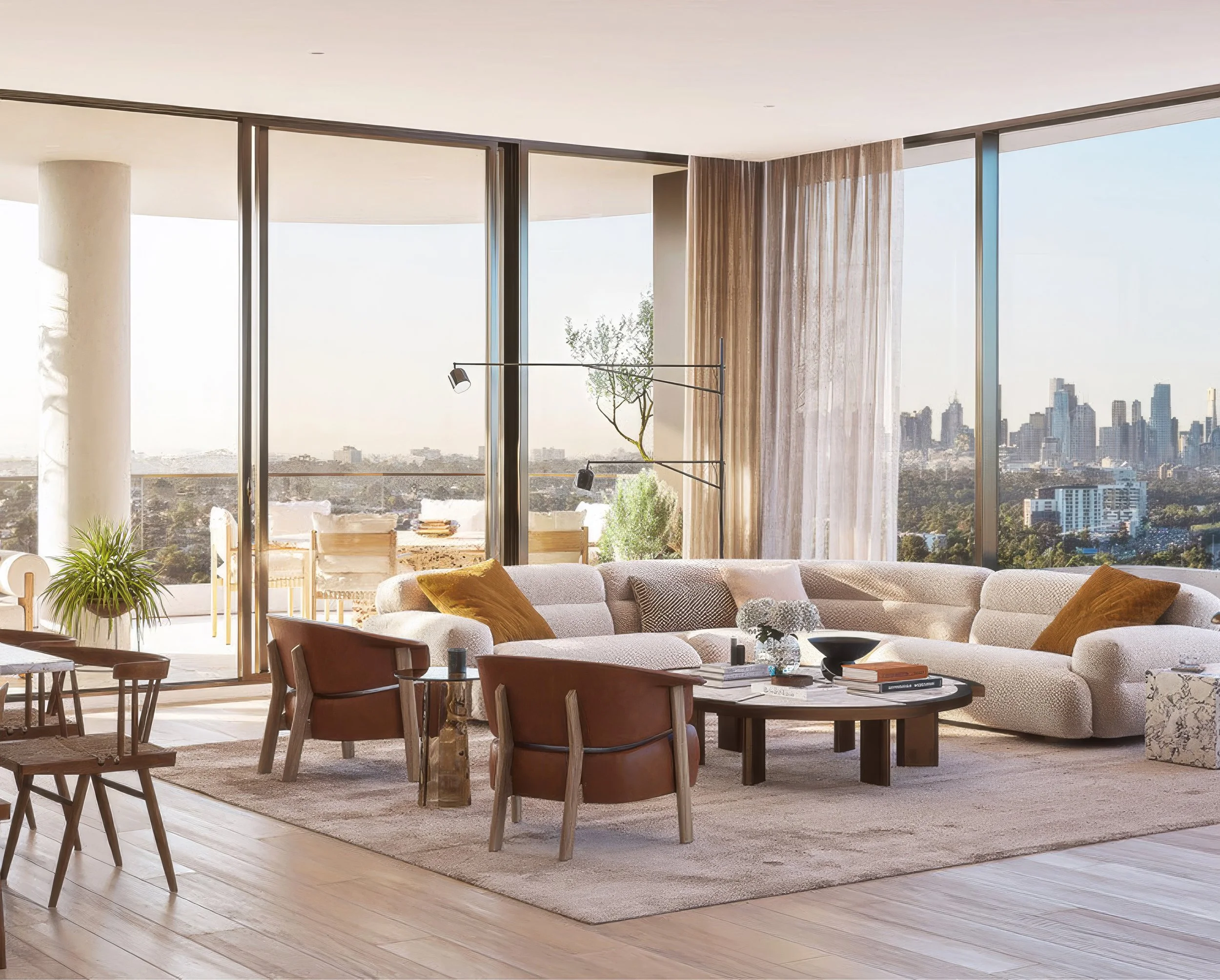 Modern living room with large floor-to-ceiling windows offering a city skyline view. The room features a beige sectional sofa with mustard and gray pillows, a dark wood coffee table, and a patterned rug. There are wooden chairs and a dining table in the background, along with a plant and a floor lamp.
