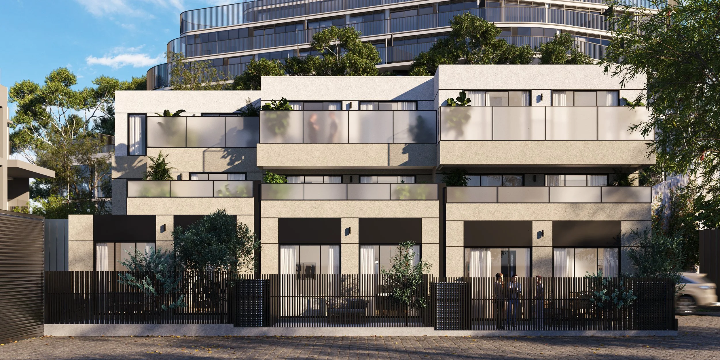 A modern multi-story residential building with white exterior walls, glass balconies, and greenery on the terraces. The building is surrounded by trees and a black fence, with a clear blue sky overhead.