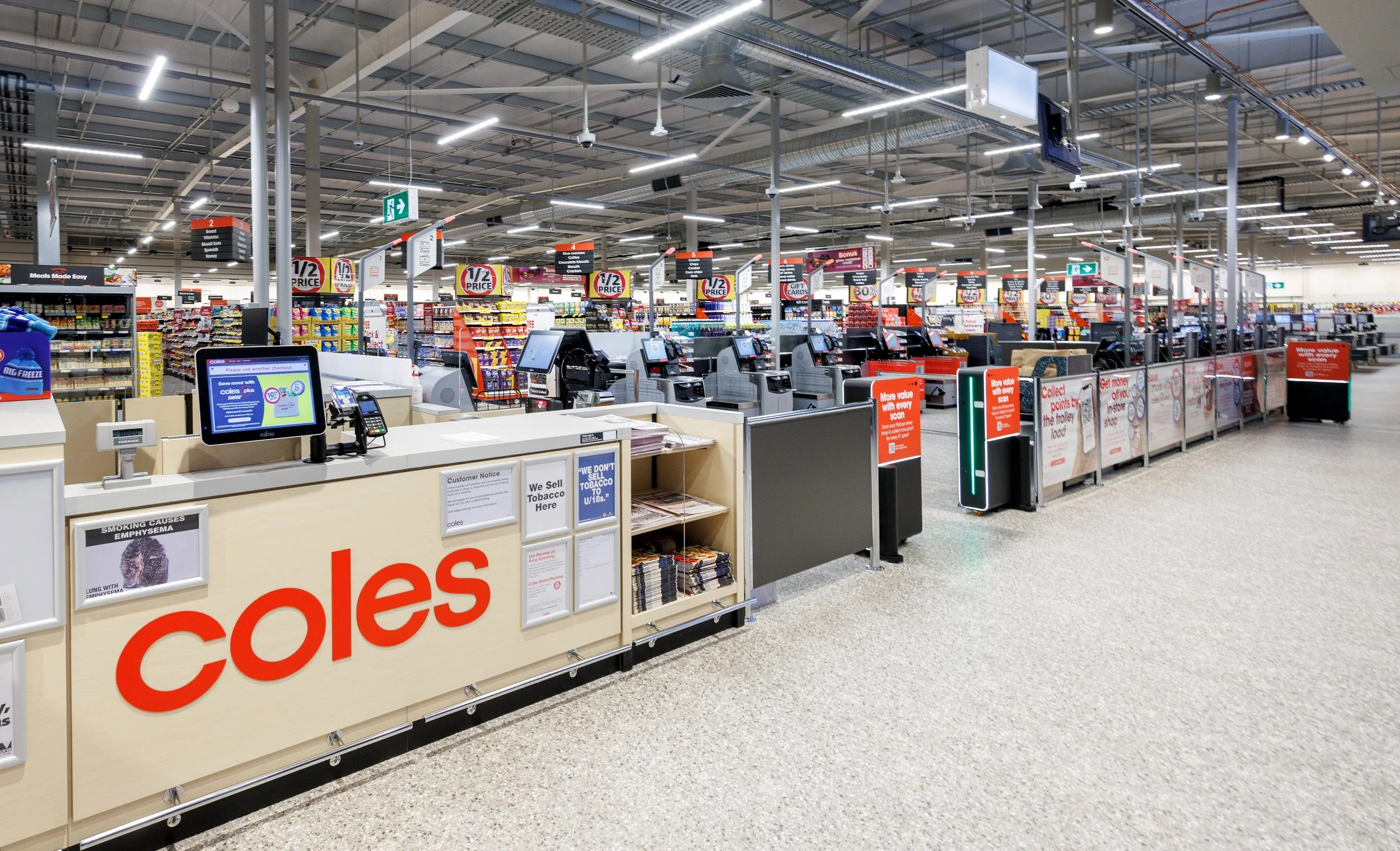Interior of a large retail store, with checkout counters and shopping aisles visible in the background.