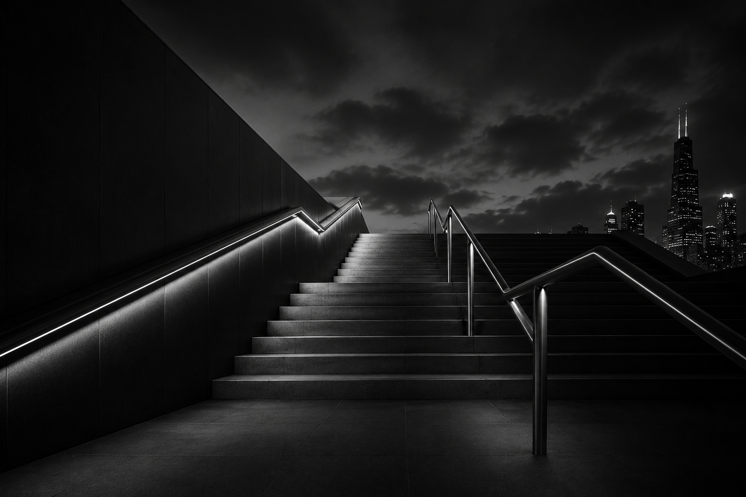 Nighttime cityscape with stairs and handrails in black and white, overlooking a city skyline with tall buildings and dark cloudy sky.