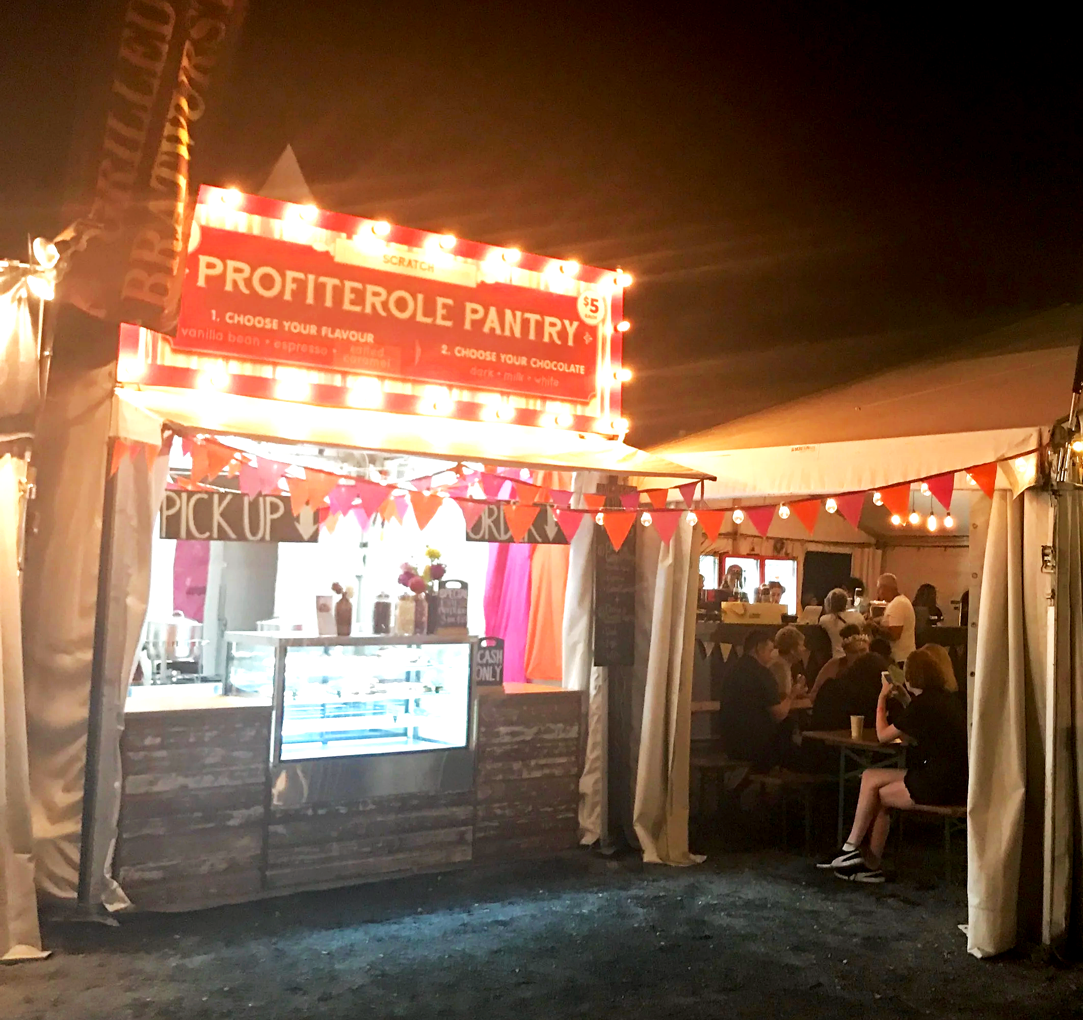 The Profiterole Pantry festival stall serving handcrafted profiteroles at a music festival.