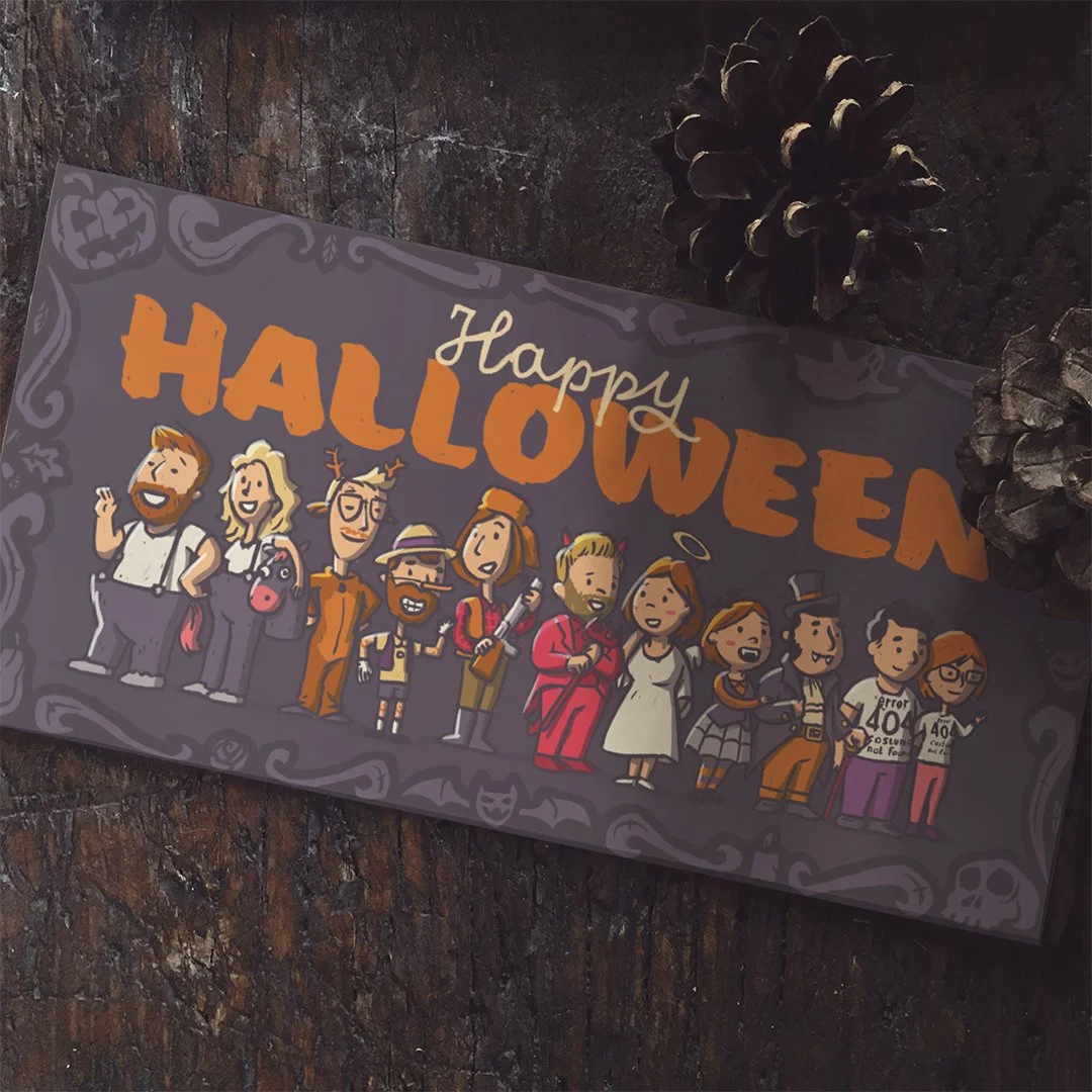 A Halloween greeting card featuring illustrated characters dressed in costumes, with the text 'Happy Halloween' at the top, sitting on a dark textured surface with pinecones nearby.