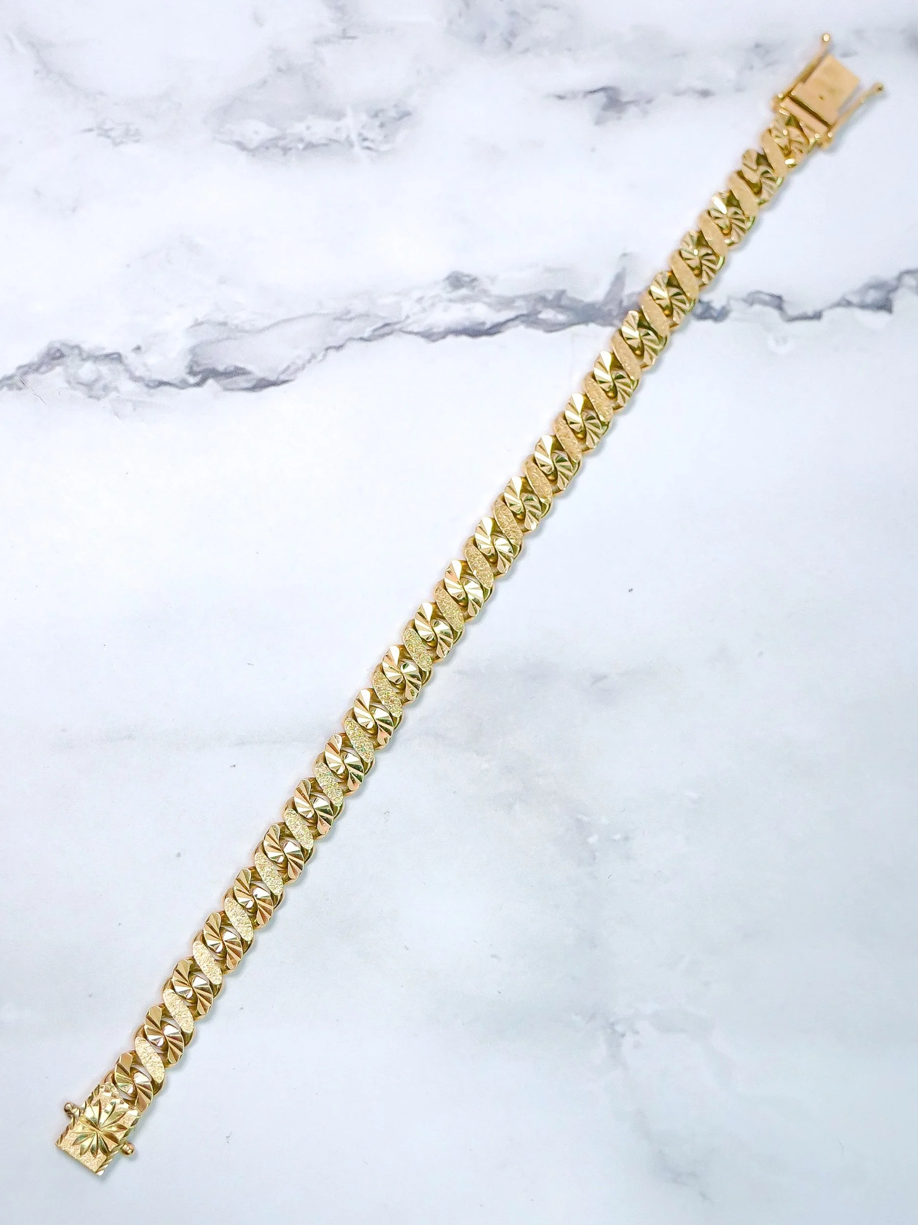 Figure 8 link bracelet in 9k gold laid flat, full length