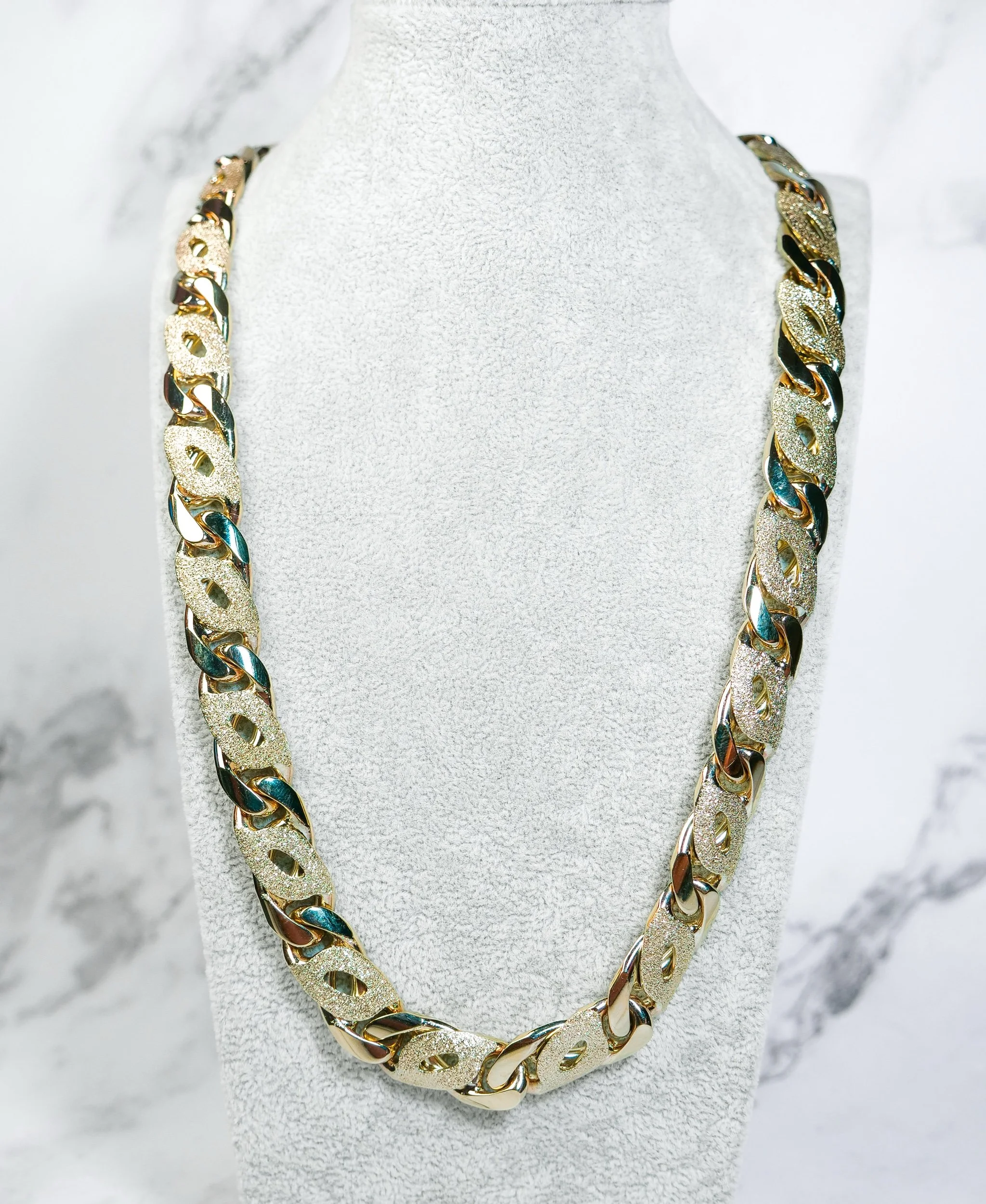Birdseye link chain in solid 9k gold with high-polish and sandblasted links on a neck display