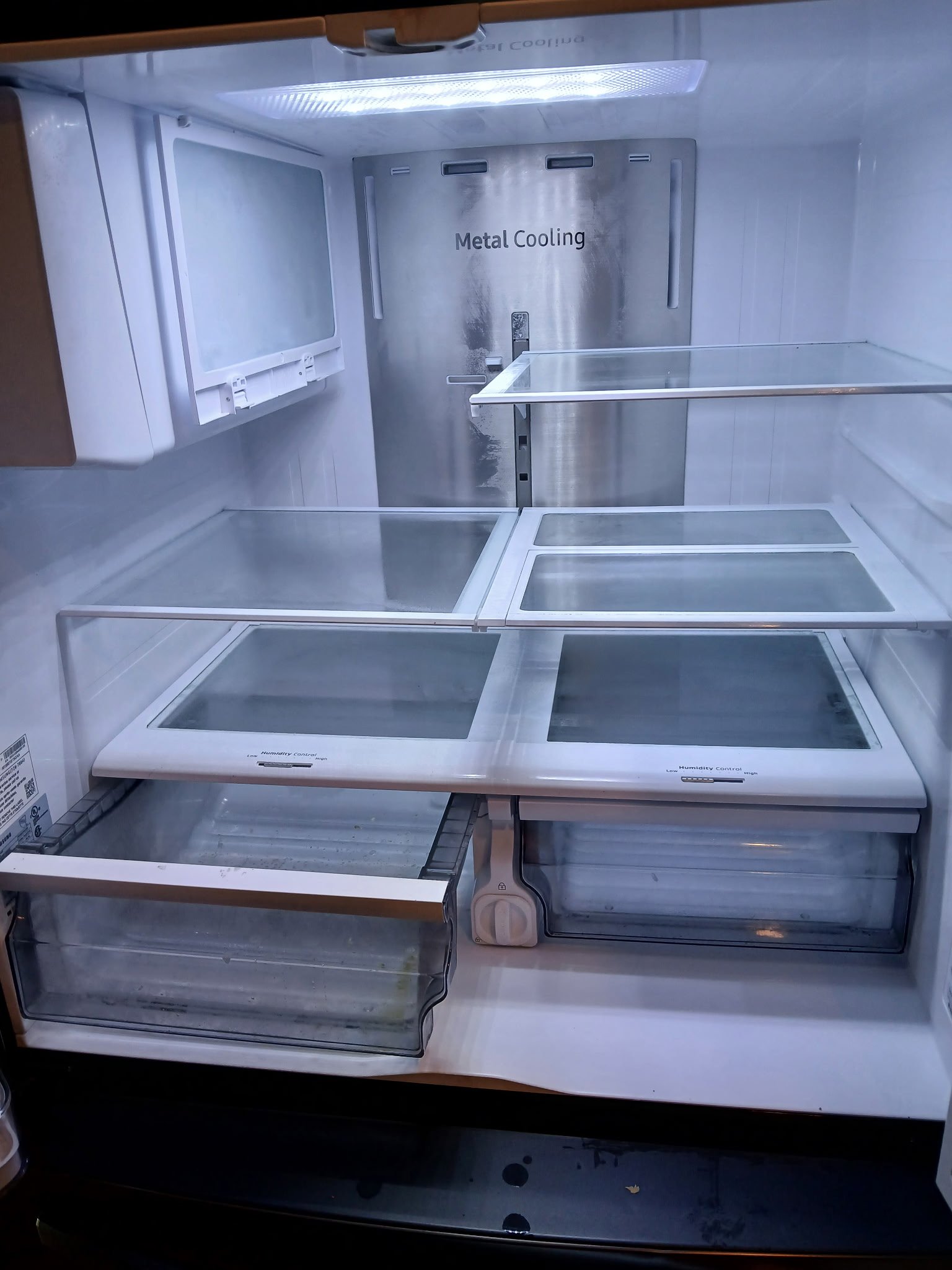 Before view of a residential refrigerator interior with visible food spills, sticky residue, and crumbs on the glass shelves and crisper drawers.⁠