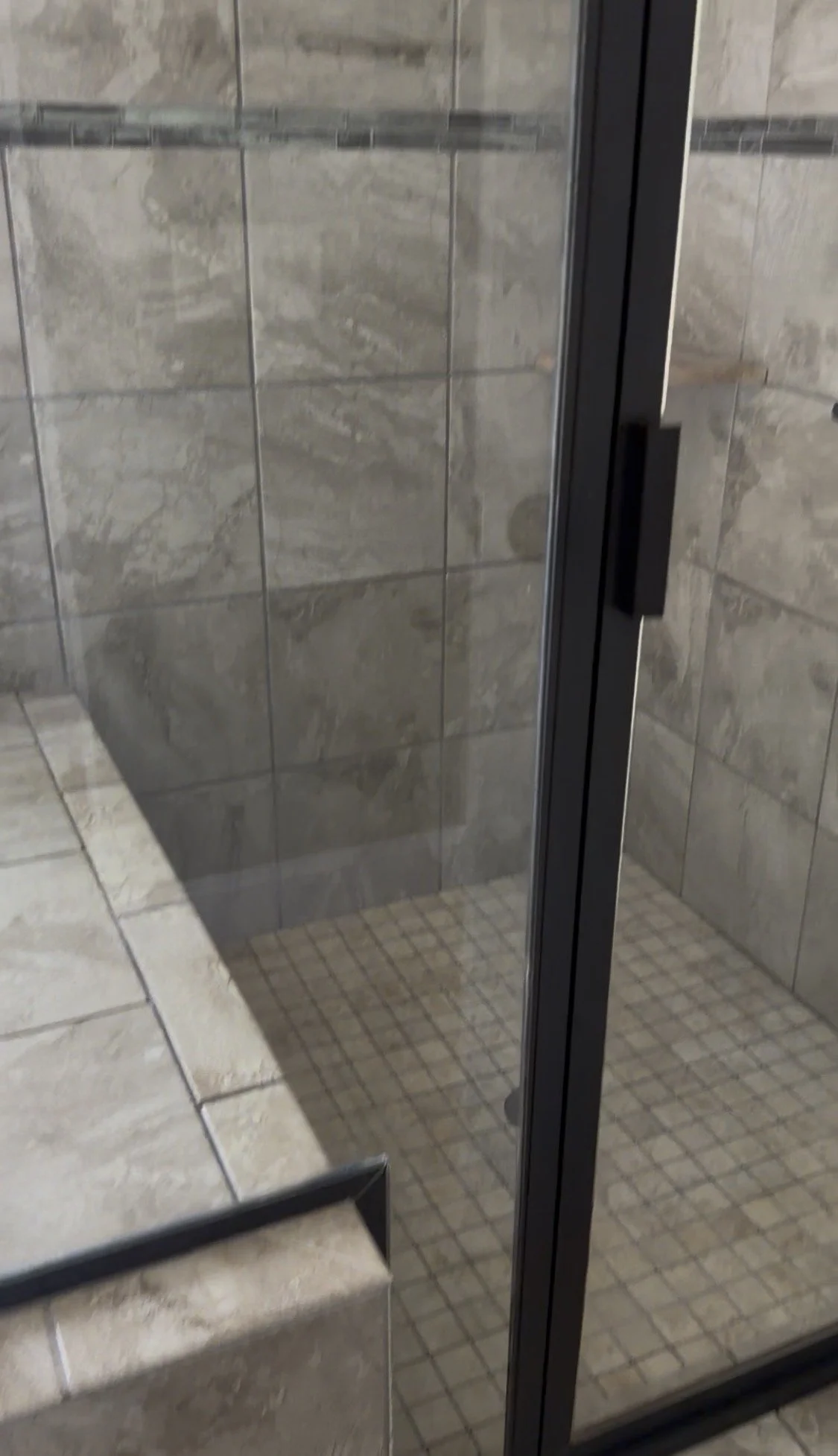 Crystal-clear, pristine glass shower doors completely restored and free of soap scum following an intensive residential move-out deep clean by TerraPro.⁠