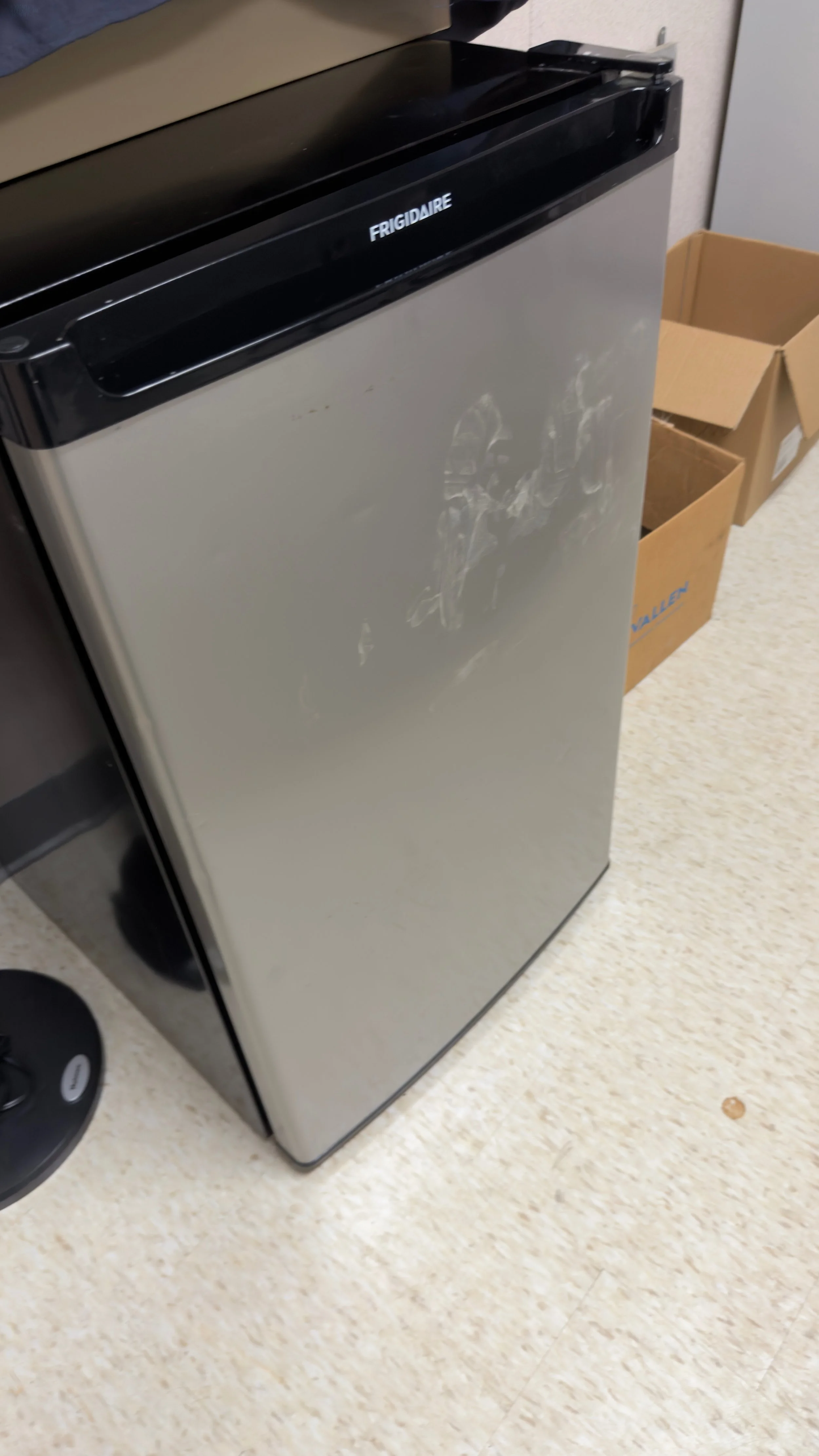 Before view of a stainless steel office breakroom mini-refrigerator covered in heavy grime, grease smudges, and fingerprints.⁠