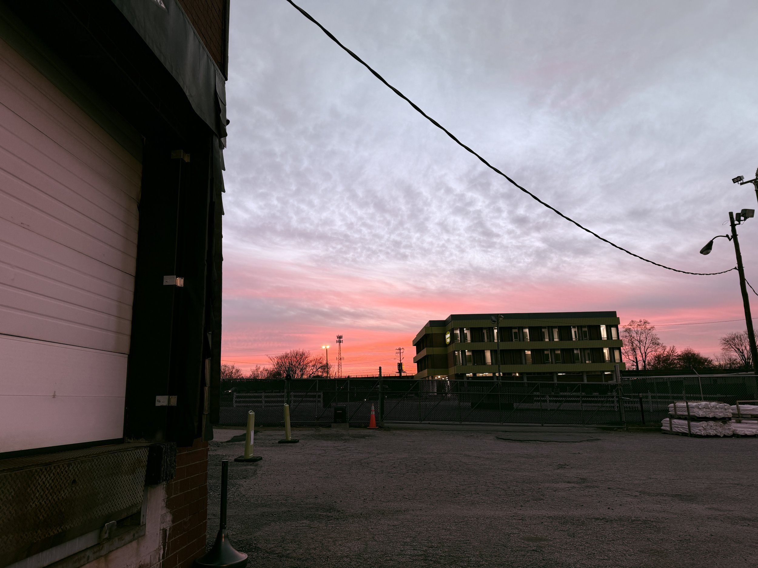 ⁠A beautiful vibrant pink twilight sunset over the commercial ULCS facility compound in Winston-Salem, NC, following an outdoor grounds trash pickup.⁠