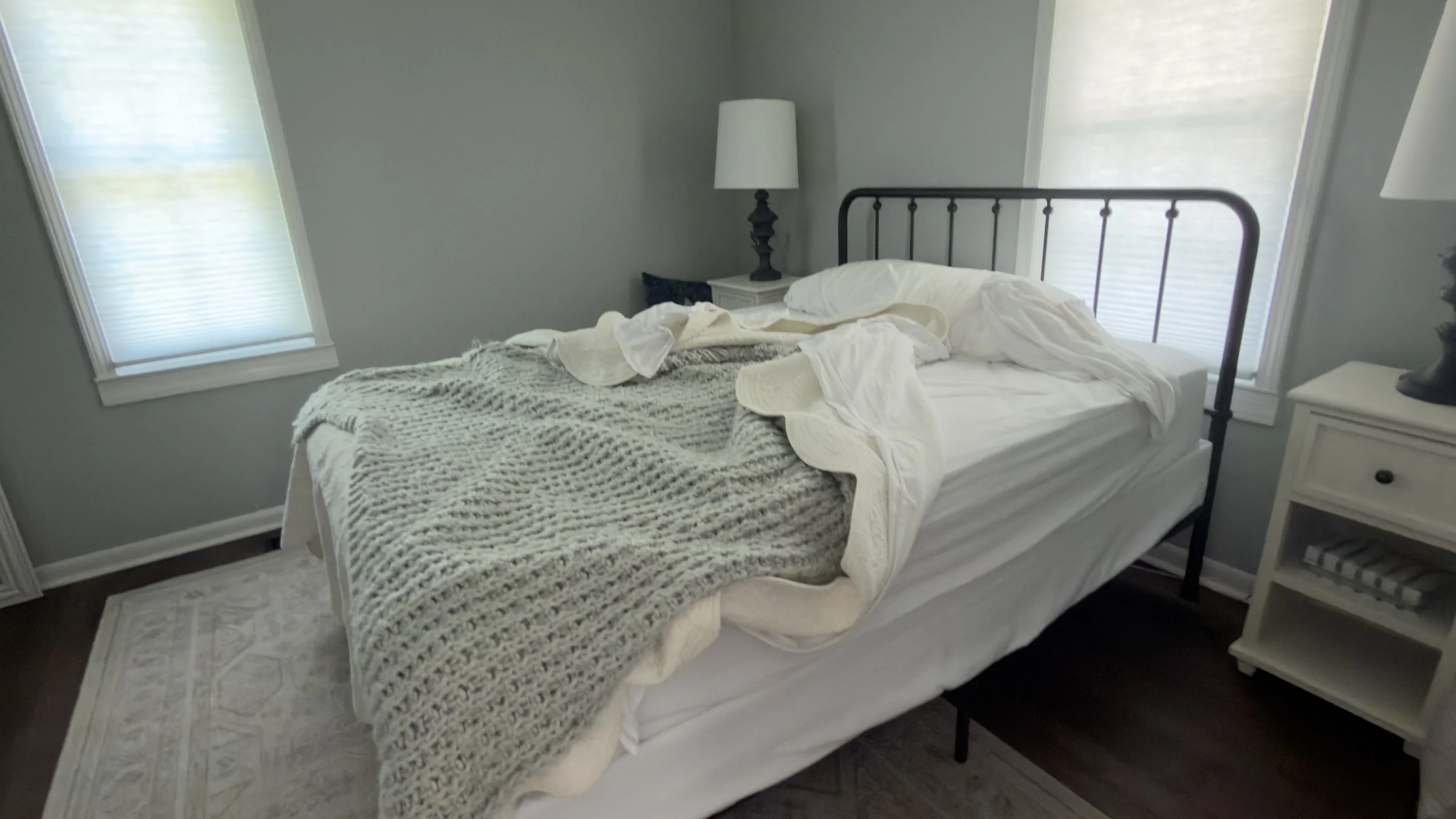 An unmade bed with ruffled sheets and blankets inside a vacation rental bedroom prior to a professional property management turnover service by TerraPro.⁠