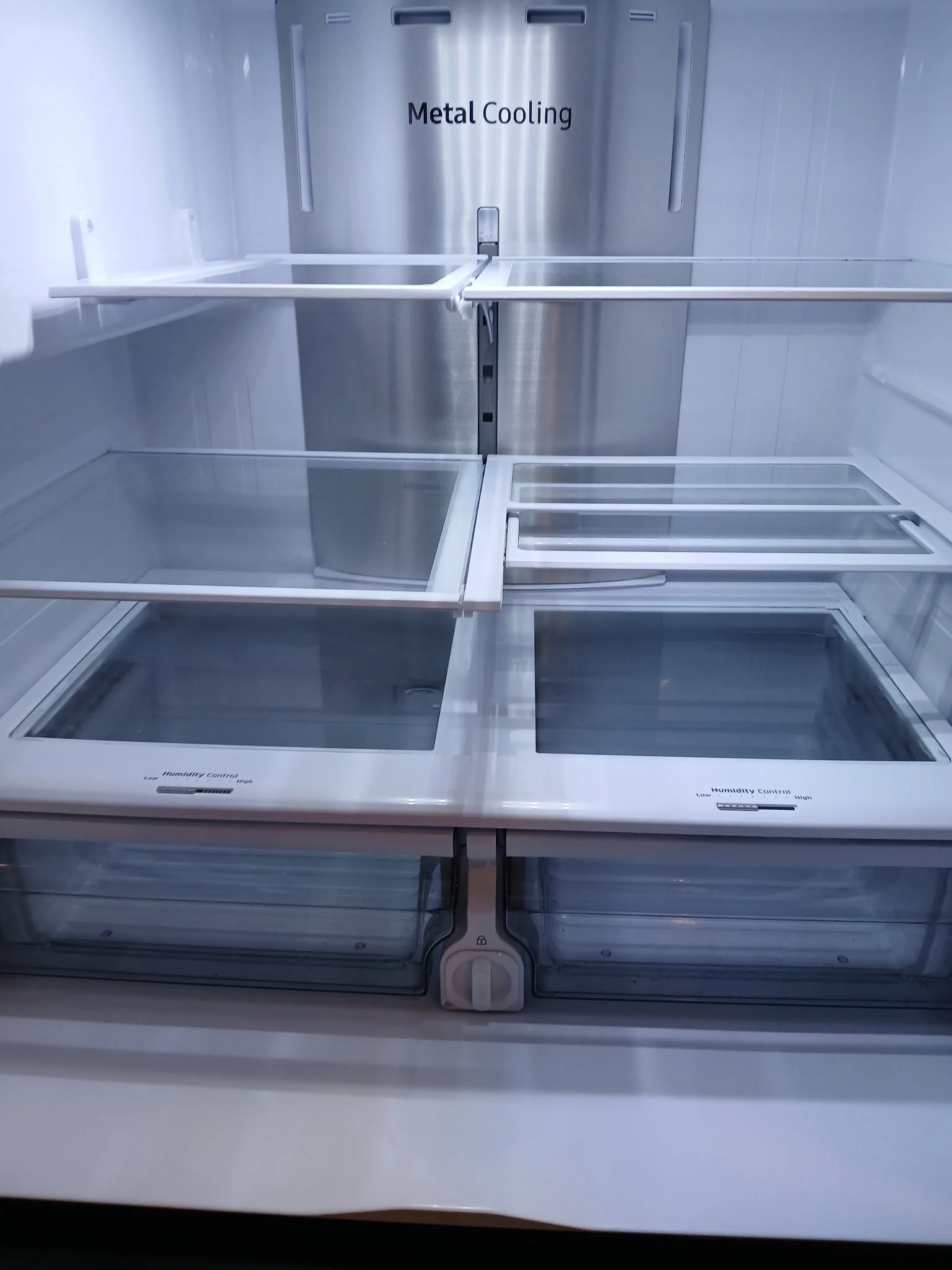 After view of a completely sanitized and spotless refrigerator interior with crystal-clear glass shelving, part of a detailed move-out deep clean by TerraPro.⁠