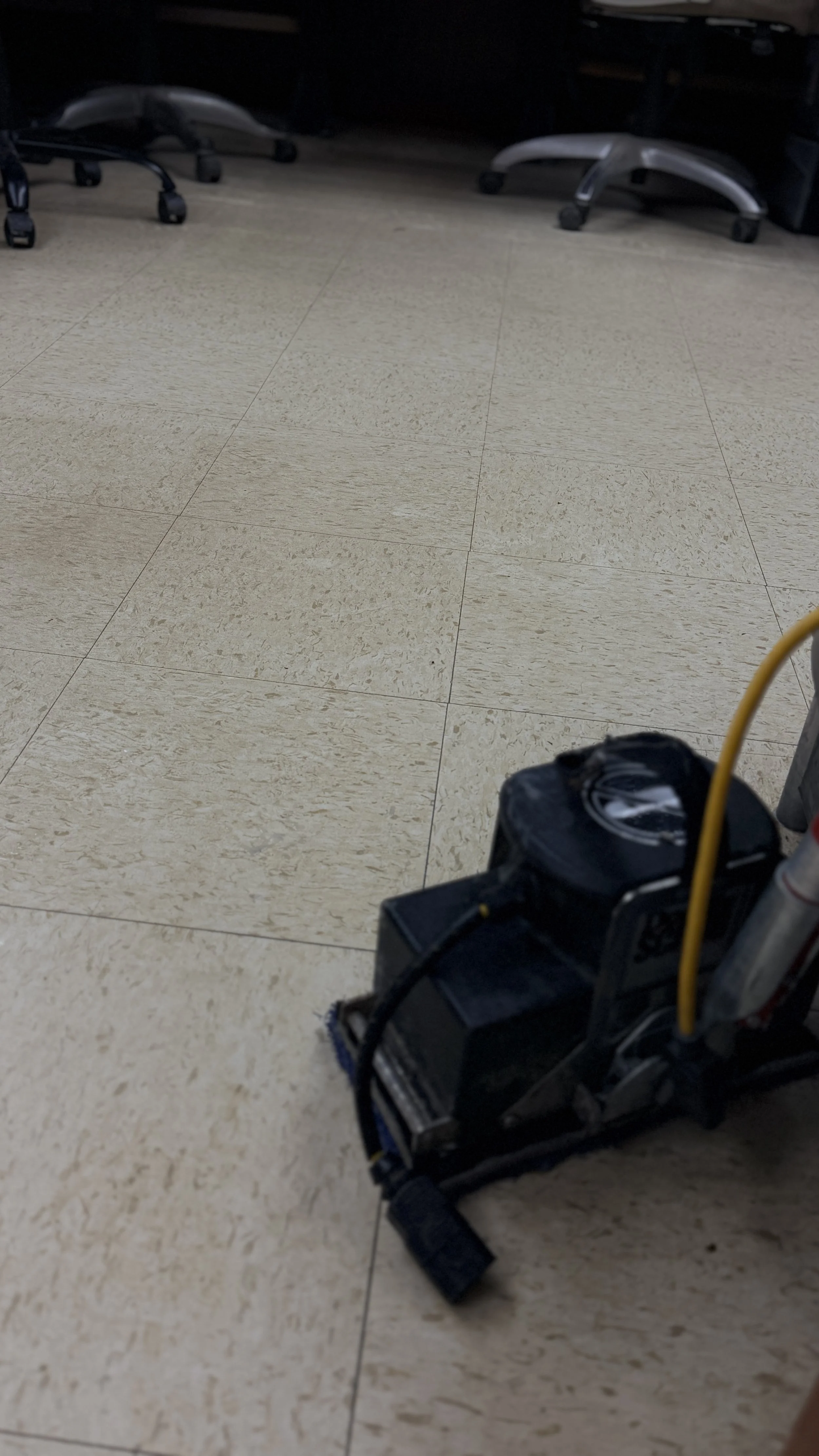 A commercial Square Scrub Doodle floor scrubber stripping deep grime from composite VCT tiles at Pike Electric, managed by TerraPro.⁠