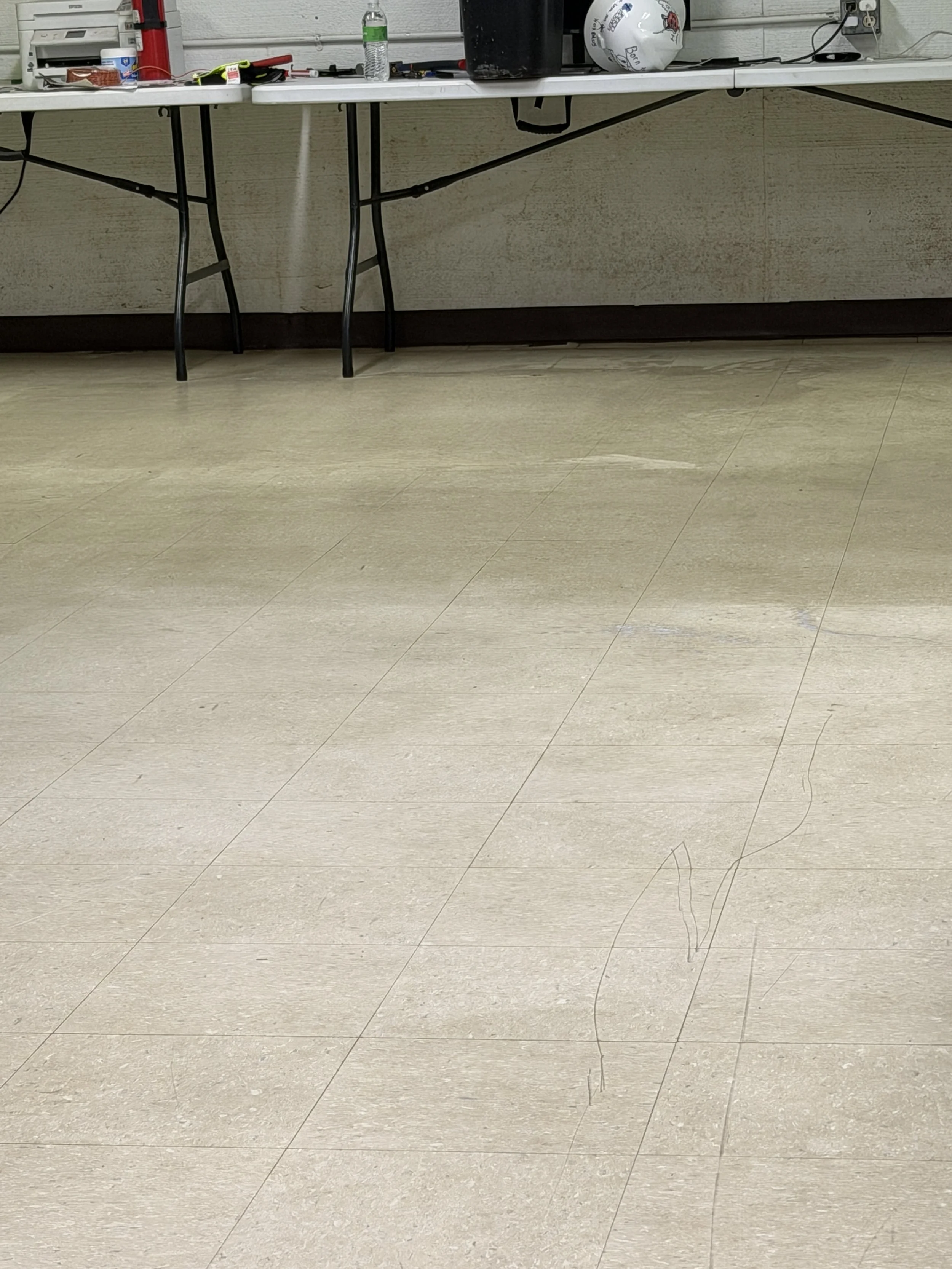 ⁠An in-progress view of a commercial VCT floor sealant application, showcasing a fresh polymer protective layer being expertly laid down in the material handler's office at Carolina Power.⁠