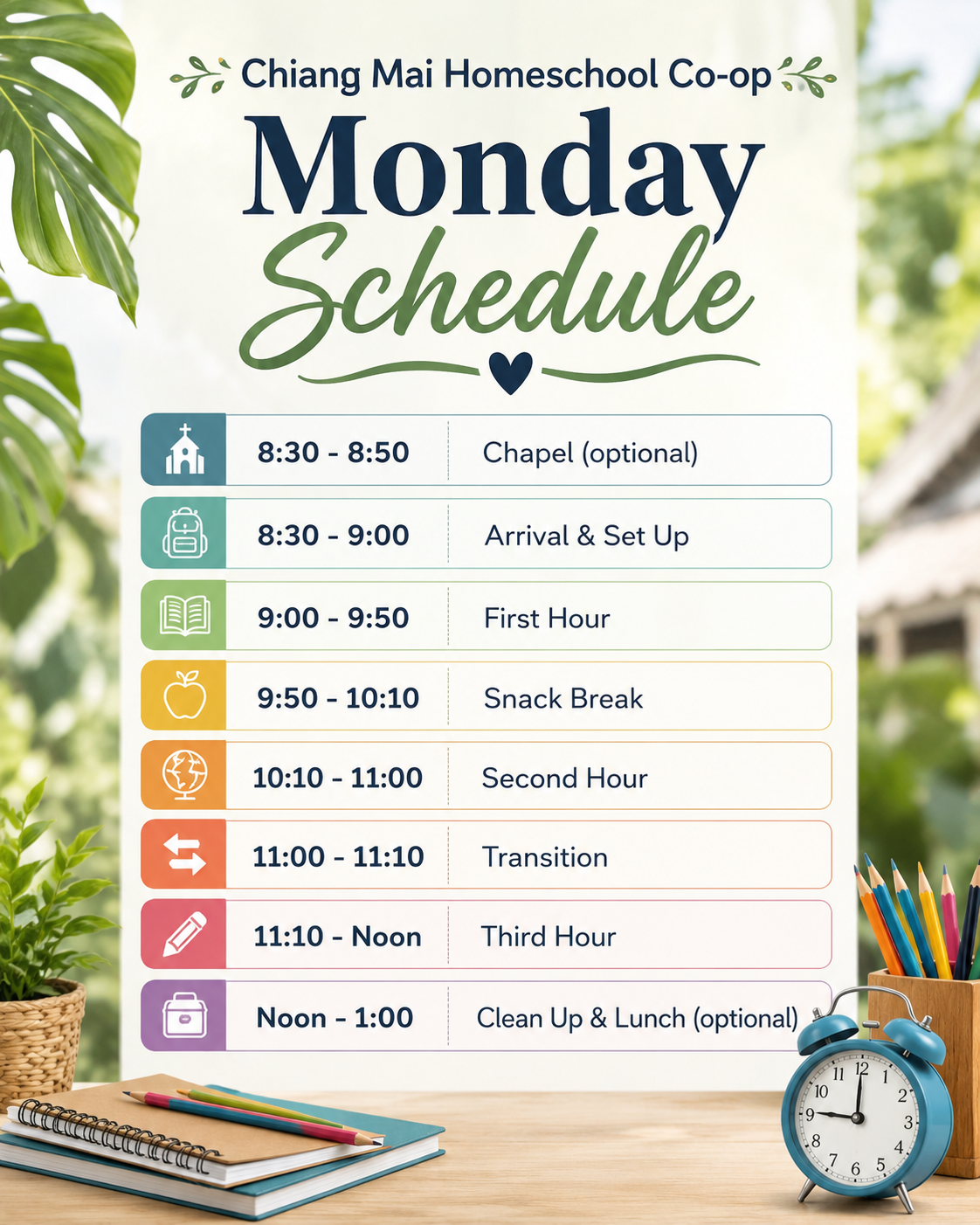 Schedule for Chiang Mai Homeschool Co-op Monday with activities and times, including optional chapel, arrival and set-up, first hour, snack break, second hour, transition, third hour, and optional clean up and lunch, displayed on a board with a clock, pencils, notebooks, a plant, and colored pencils on a table in the background.