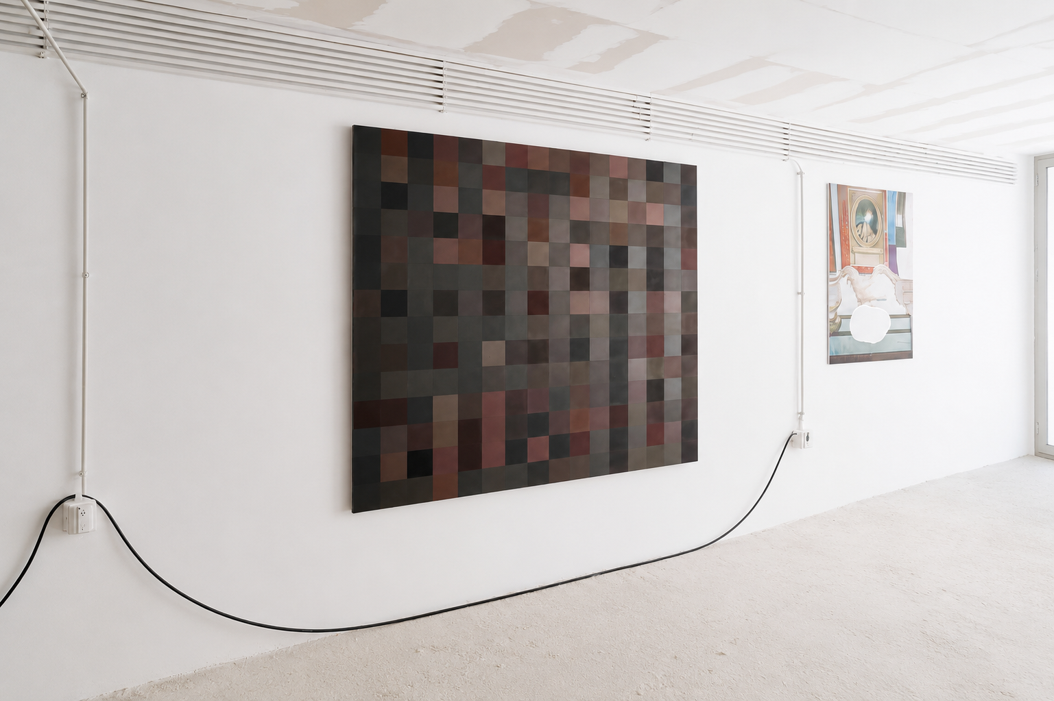 An art gallery features two paintings on a white wall with visible electrical wiring and outlets. The larger painting on the left consists of a grid of small, dark, and muted-colored squares. The smaller painting on the right displays a classical-sty