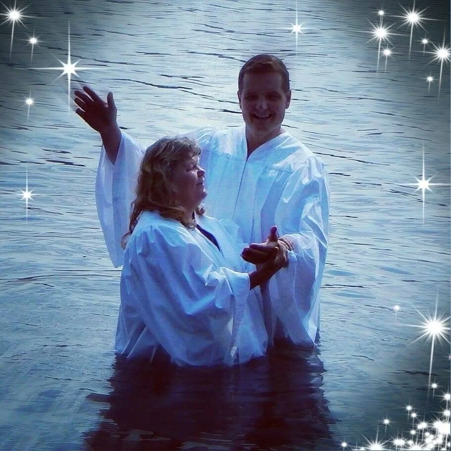Being baptized in a lake on a sunny day