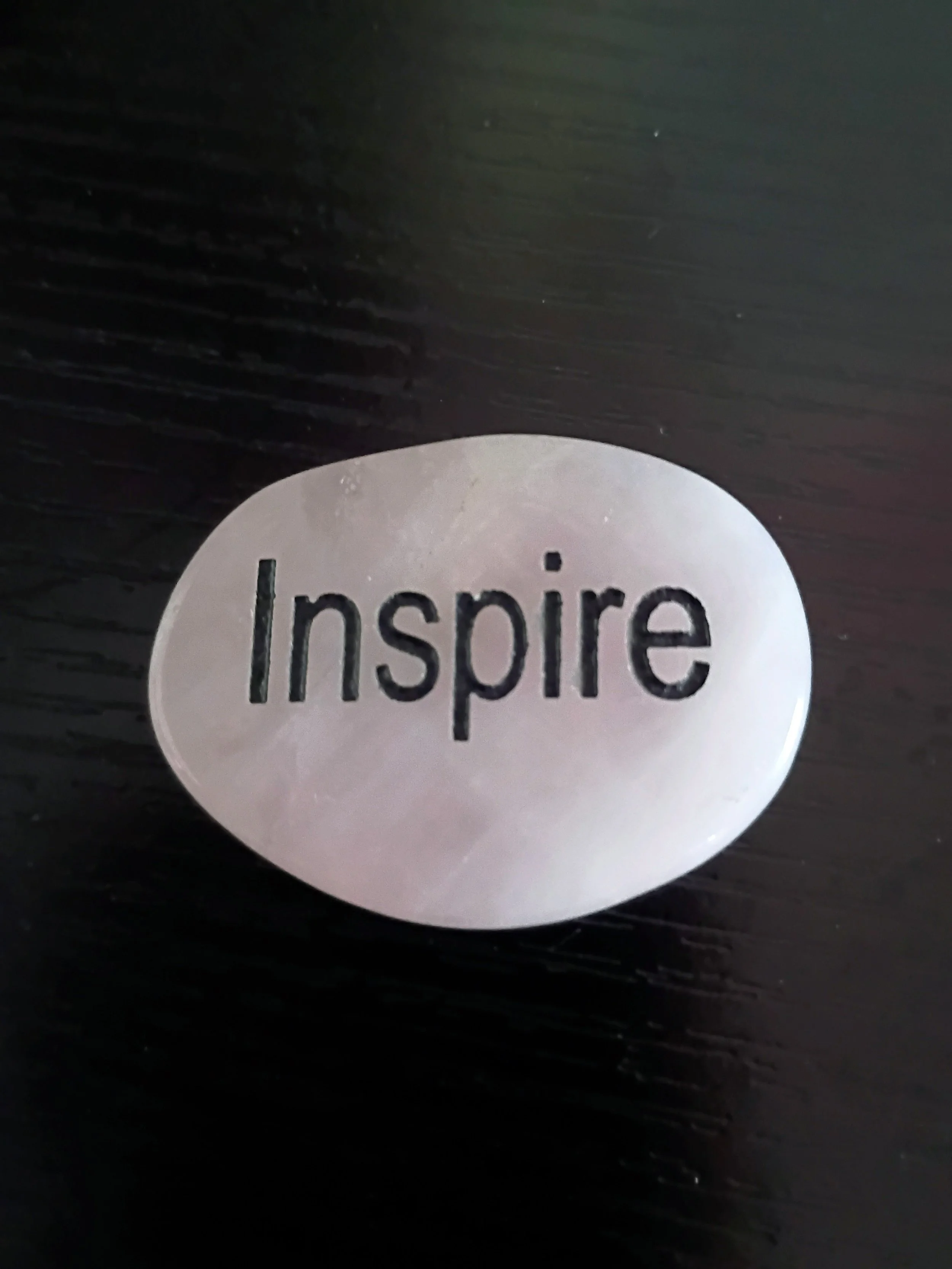 white rock with the word inspire printed on it