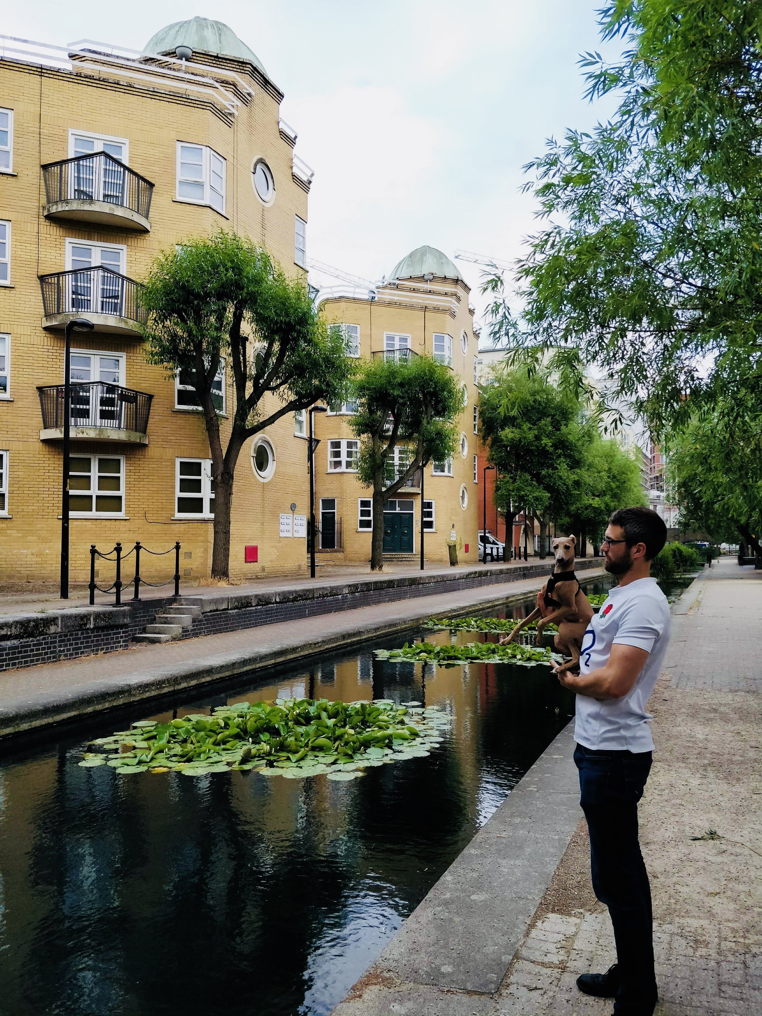 Ryan Minti, non-monogamy expert and mentor with his dog by a canal