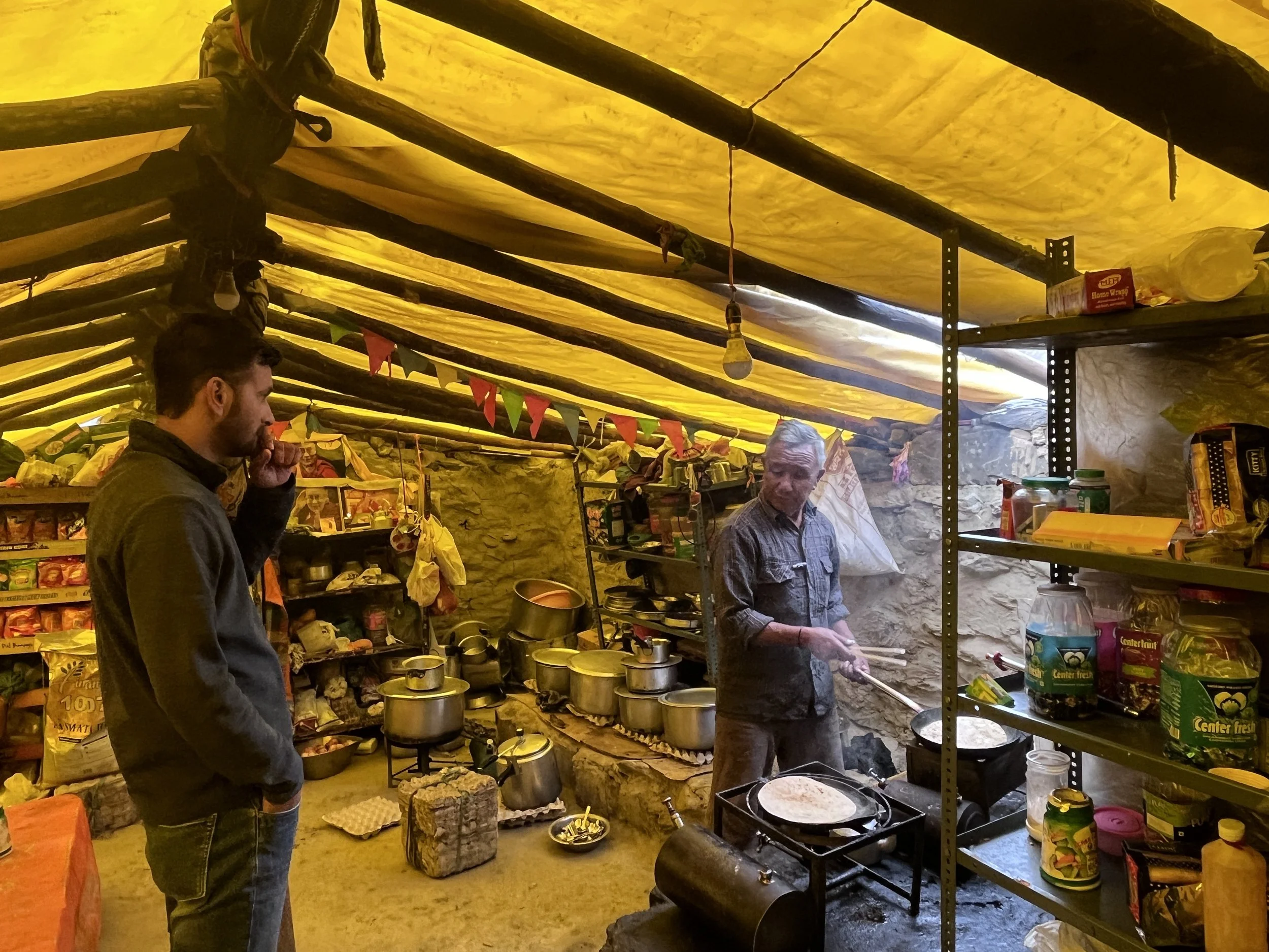 A traveller waiting for his food order in the rustic Chacha Chachi Dhaba in Batal, Spiti, experiencing the beauty of slow travel.