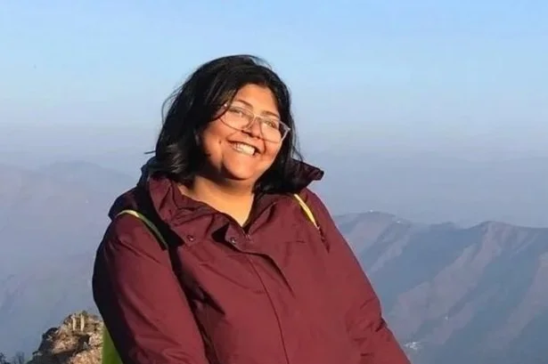 A happy traveller post reaching the final point of a trek in Mussoorie.