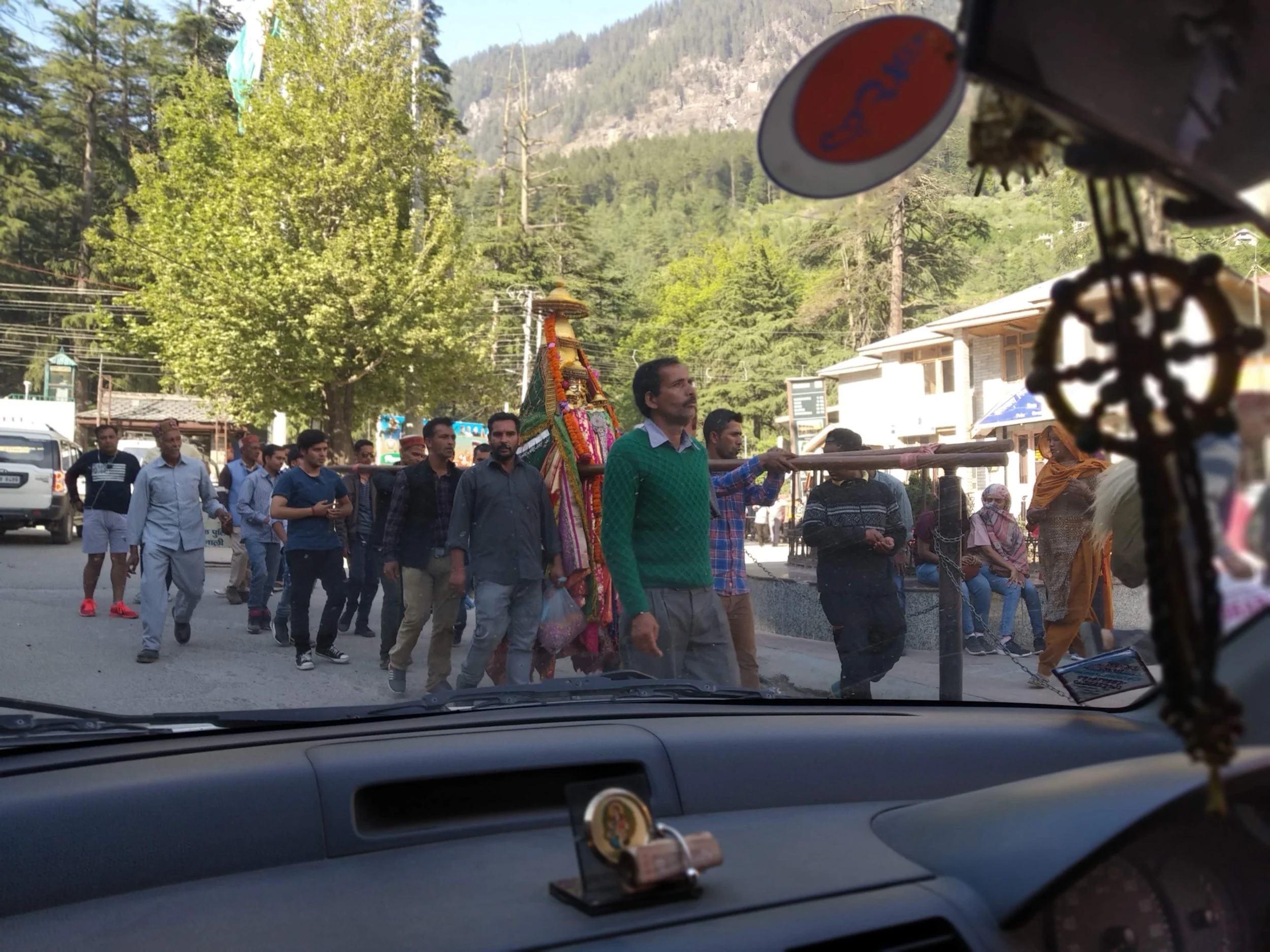 View of a procession led by the community, carrying a decorated idol as part of an experiential travel opportunity.