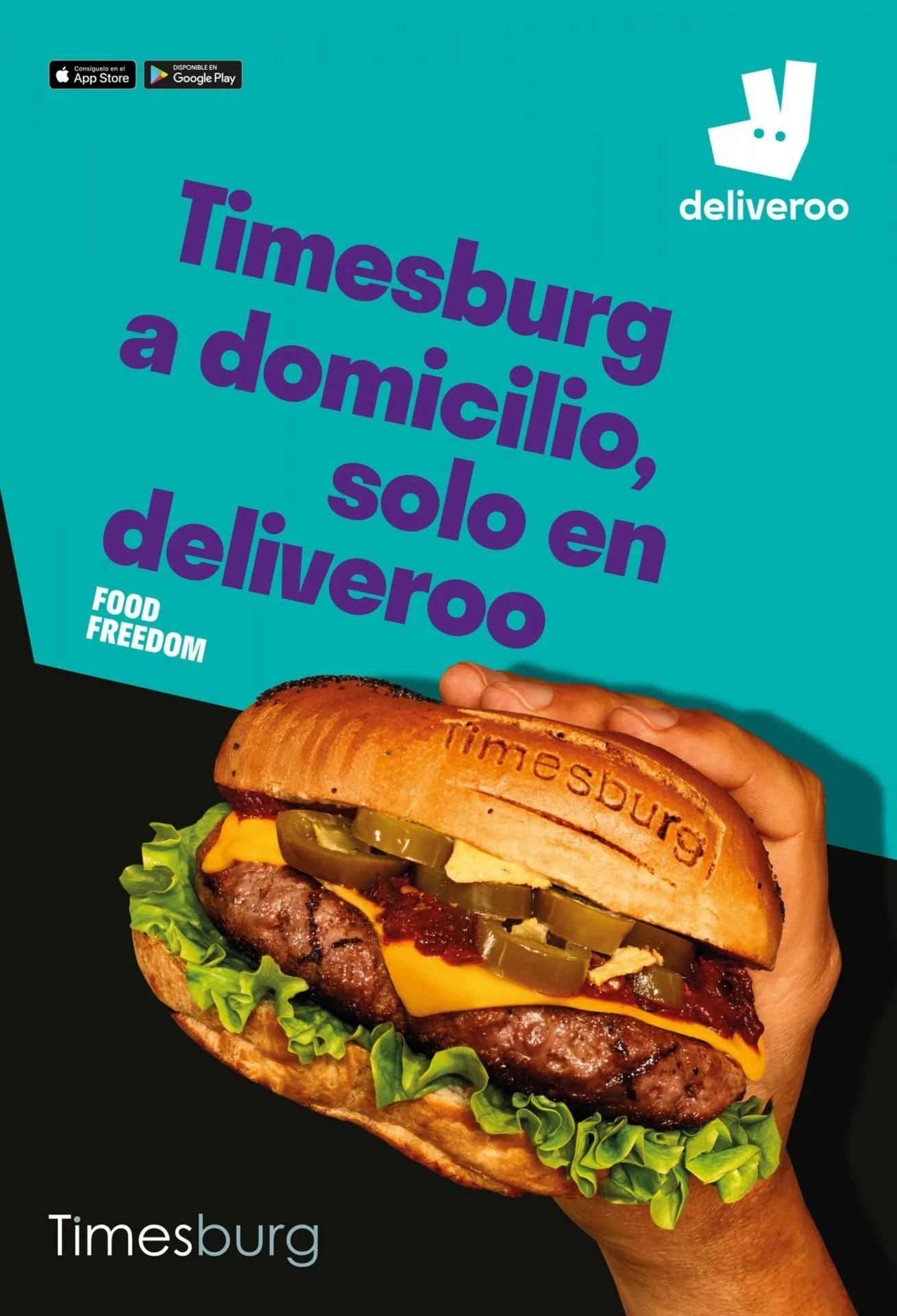A sandwich with lettuce, cheese, jalapeños, and beef patty, held by a hand, with a sticker imprint of 'Timesburg' on the bun, and a blue background with the text 'Timessburg a domicilio, solo en deliveroo' and the deliveroo logo.