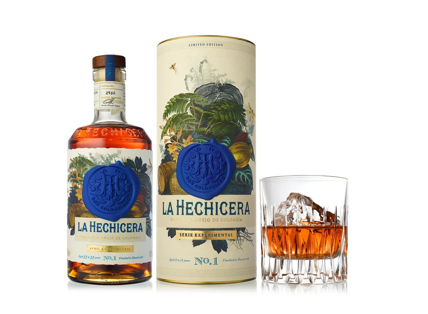 Bottle of La Hechicera Colombian rum, decorative packaging, and a glass with ice and rum