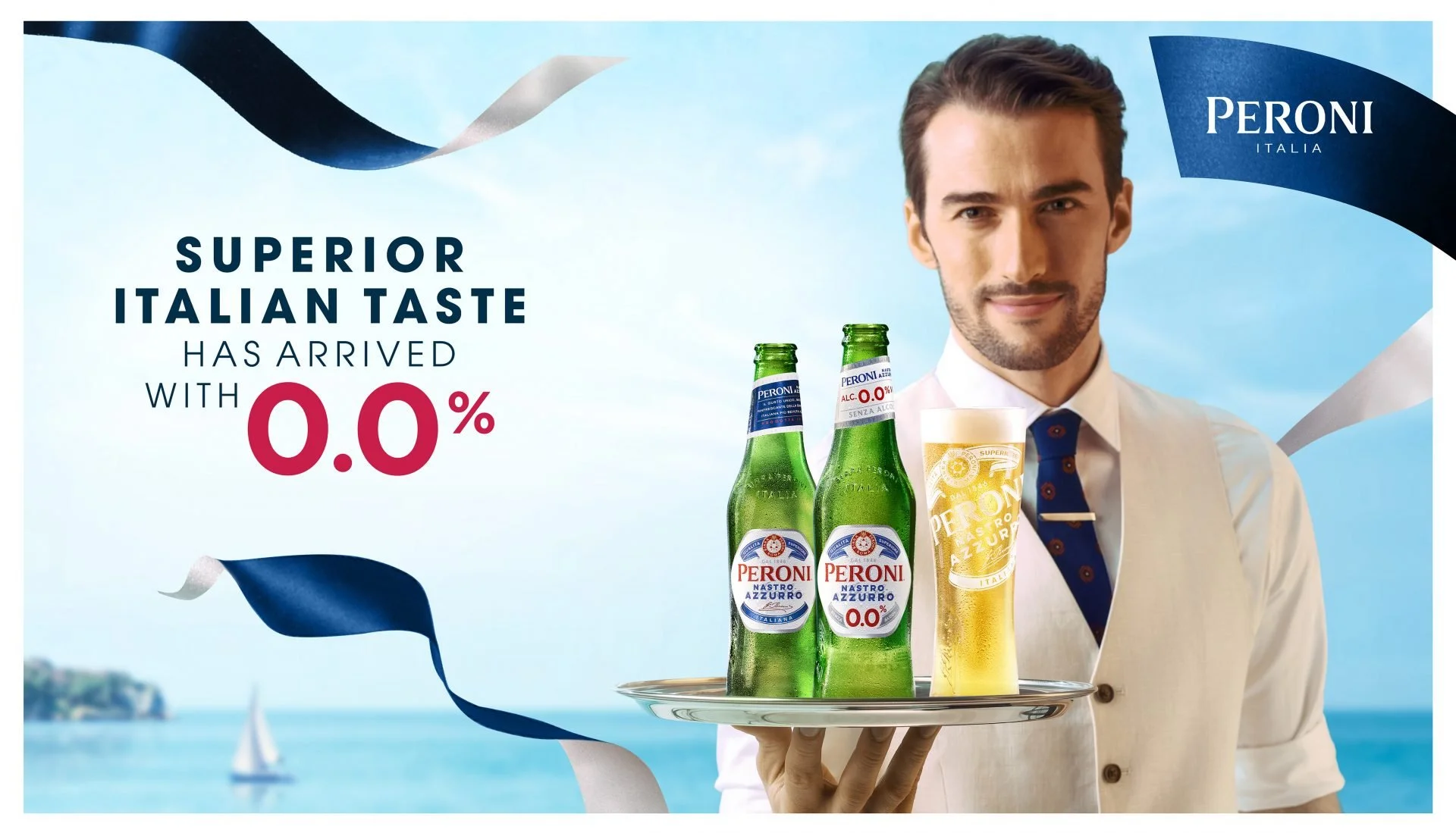 Advertisement featuring a man in formal attire holding a tray with bottles of Peroni beer and a glass of beer, with a background of a lake with sailboats. The ad highlights that the beer has zero alcohol and emphasizes superior Italian taste.