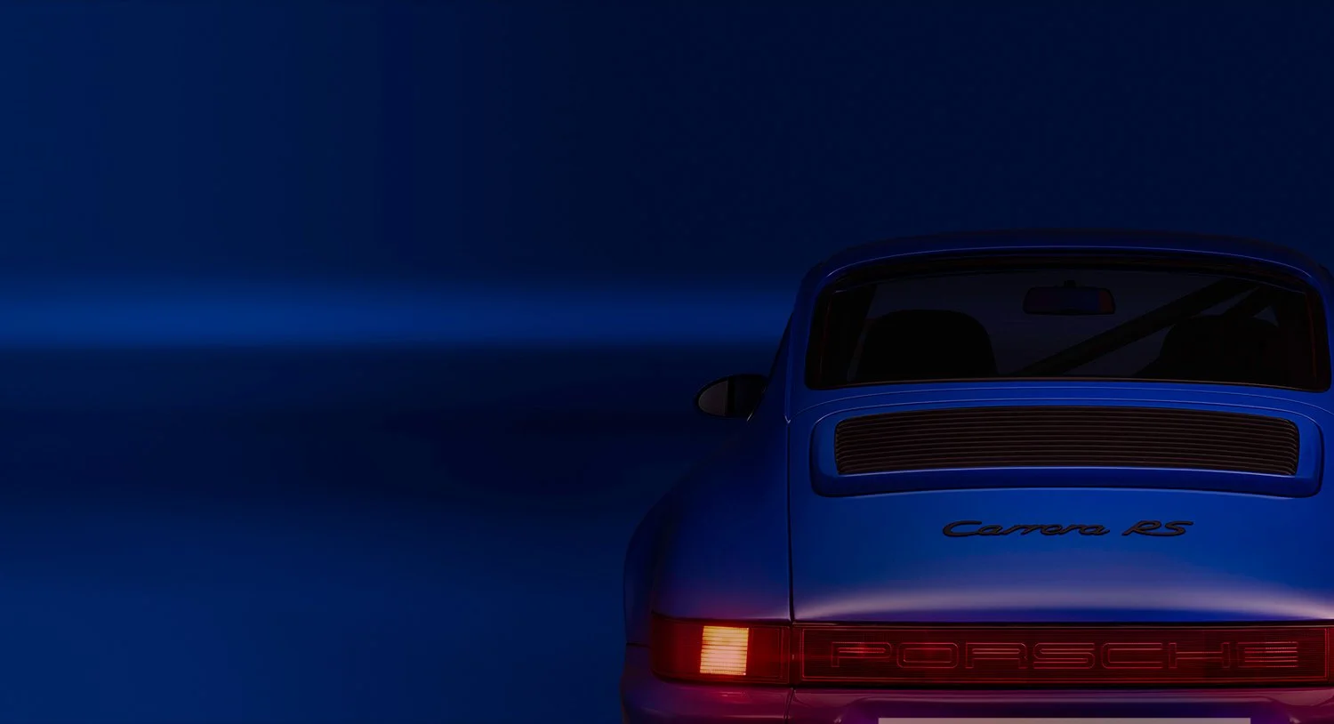 Rear view of a blue Porsche Carrera 911 RS car at night, with a dark sky in the background.