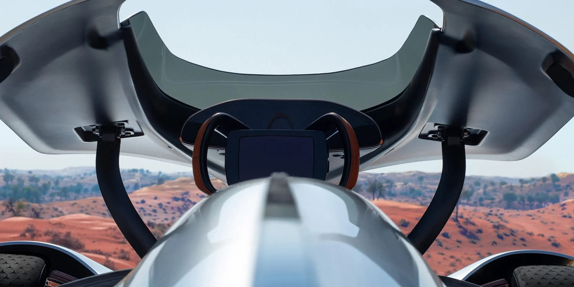 Futuristic vehicle cockpit with a large curved windshield and digital display, overlooking a desert landscape with rolling hills.