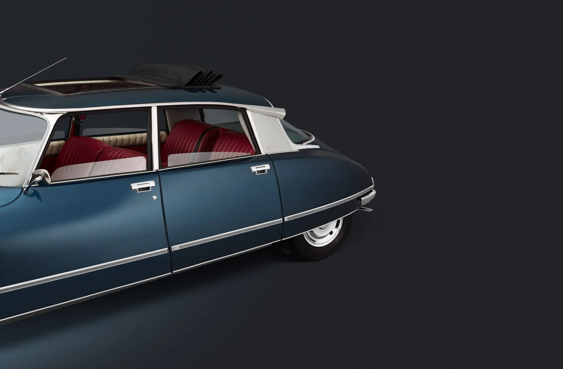A vintage blue and white station wagon car with red interior seating, viewed from a side angle against a dark background.
