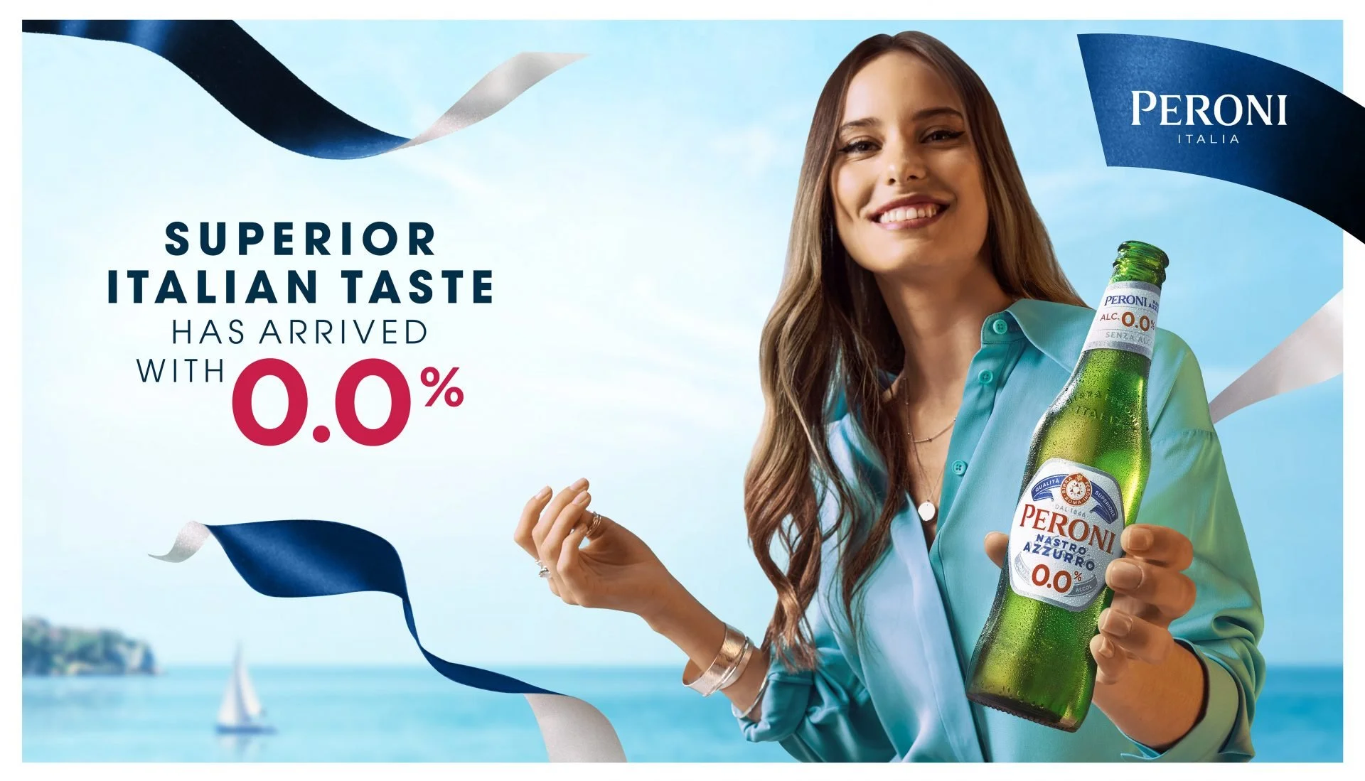 A woman smiling and holding a bottle of Peroni alcohol-free beer outdoors near a body of water with sailboats, promotional text advertising the beer's superior Italian taste with 0.0% alcohol, and decorative ribbon streamers.