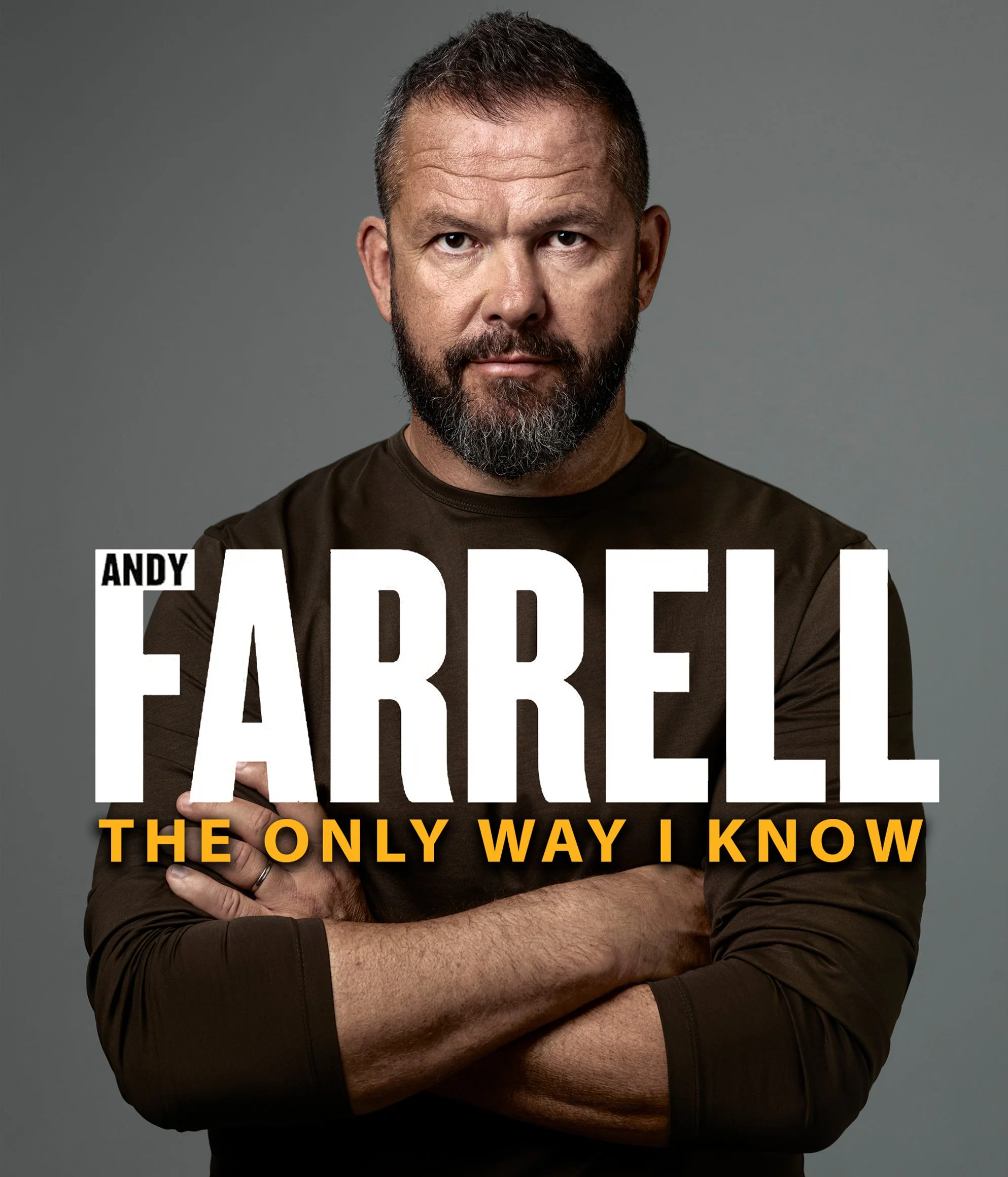 Close-up of a man with short dark hair and a beard, wearing a dark brown long sleeve shirt, with his arms crossed, against a plain gray background. The image appears to be the cover of a book or poster with the text: 'Andy Pardee The Only Way I Know'