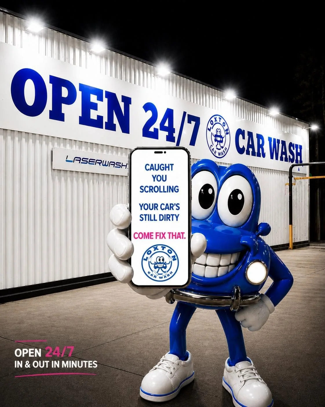 A mascot in the shape of a blue cartoon character with big eyes and a wide smile, wearing sneakers, holding a phone displaying a message about dirty car seats, standing outside a car wash that is open 24/7 at night.