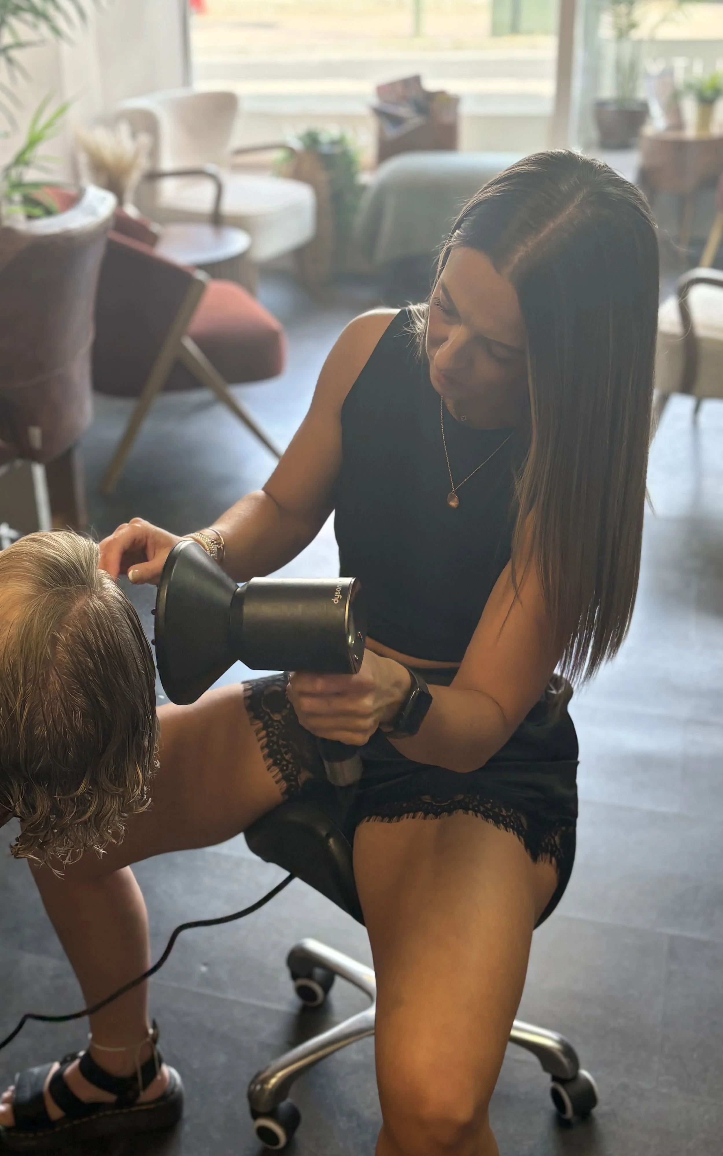 Sam curling hair in the salon