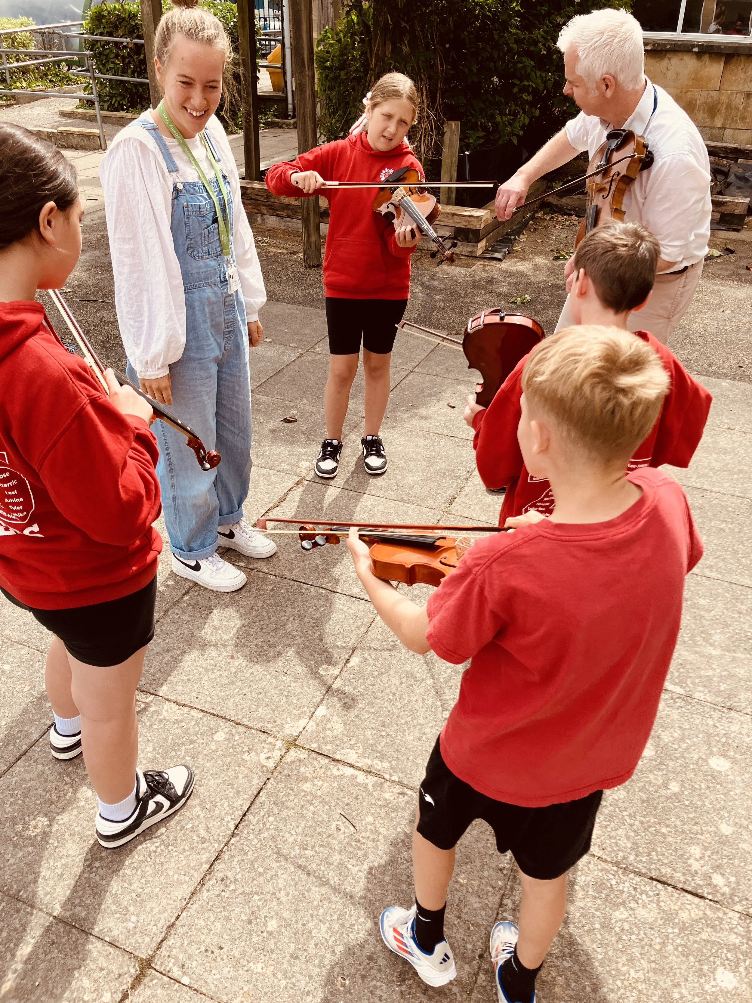 Music Leaders from Bath Philharmonic Orchestra and King Edward's School, Bath teach the violin to St Martin's Garden Primary School students.