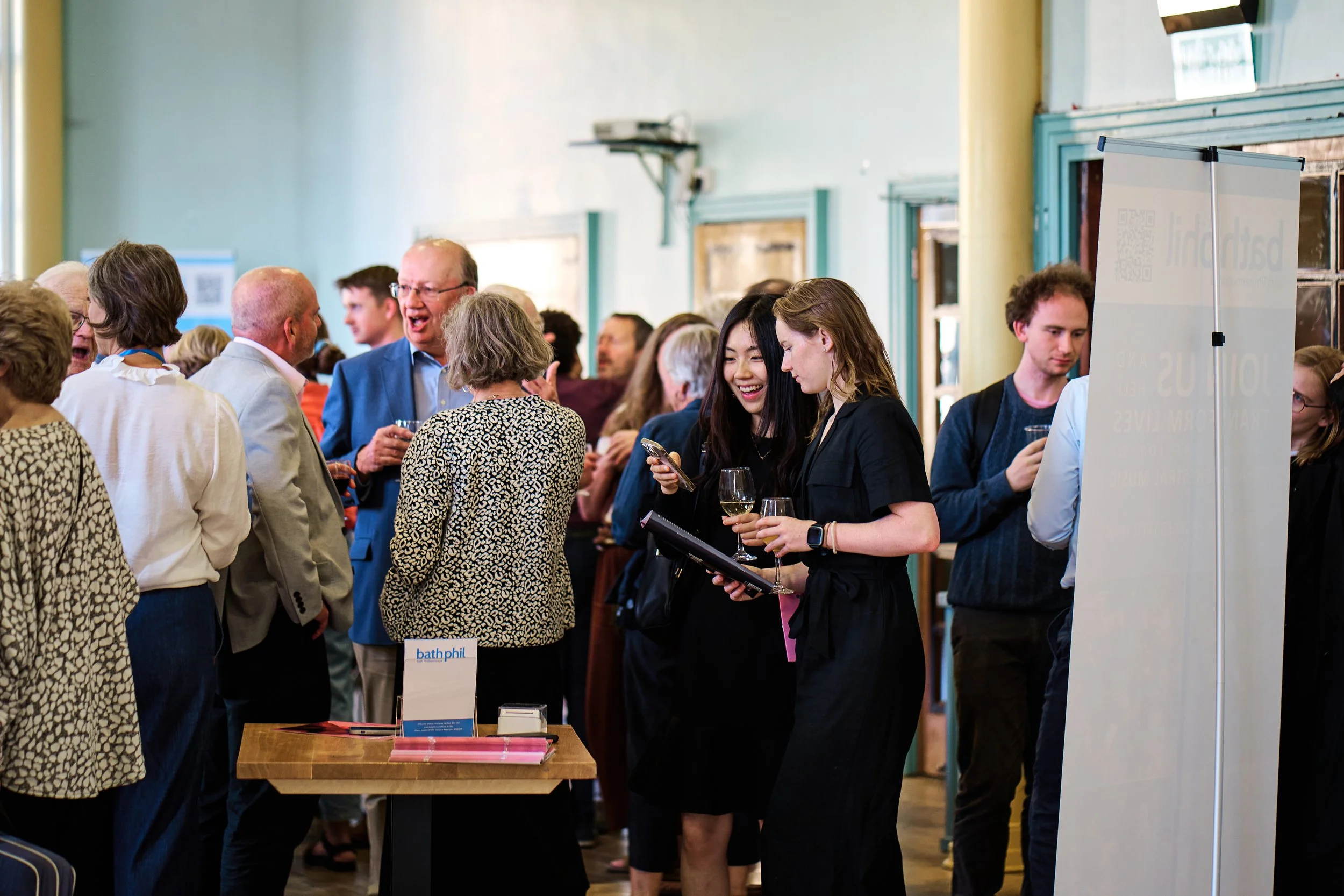 Young people mingling at a Bath Philharmonic Orchestra pre-concert reception.
