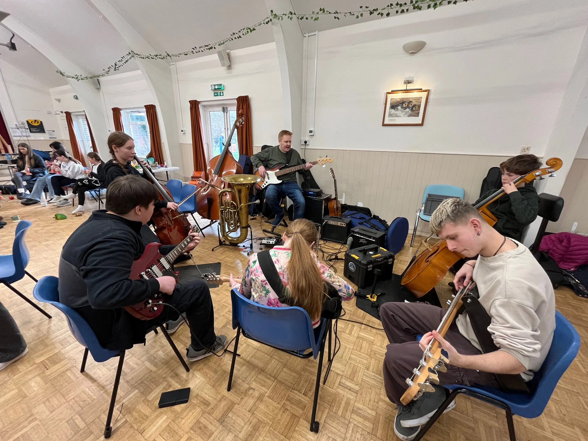Group of young carers playing and learning musical instruments.